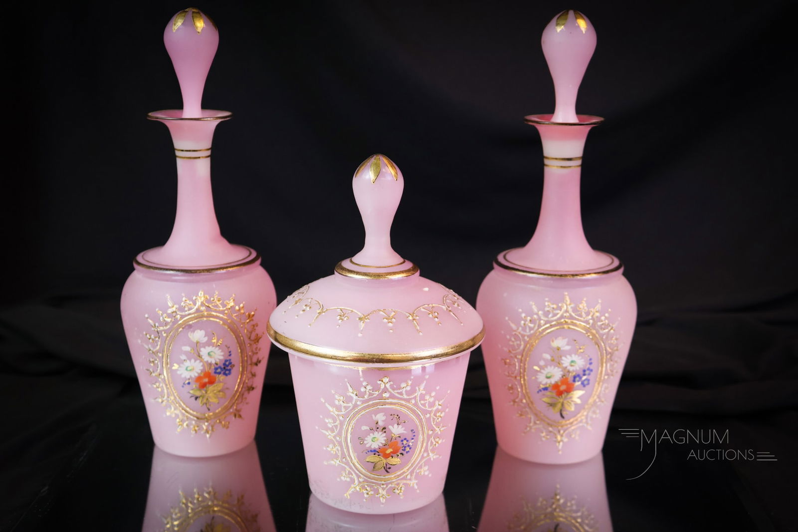 3 pc Set Victorian Opaline Glass Perfume Vanity Cologne Bottle Dresser Set: A wonderful three-piece vanity dresser set of pink decorated opaline glass. This set is made up of two perfume or cologne bottles and a covered powder jar. Each piece of the set is decorated with