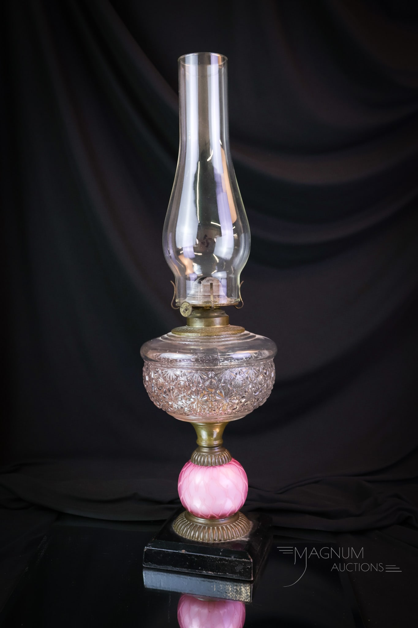Victorian Mother of Pearl Stand Oil Lamp: A rare find in Victorian mother-of-pearl satin glass. This is a stand lamp with a clear font and a pink diamond-quilt mother-of-pearl satin glass connector stem. The lamp has a cast metal black base.