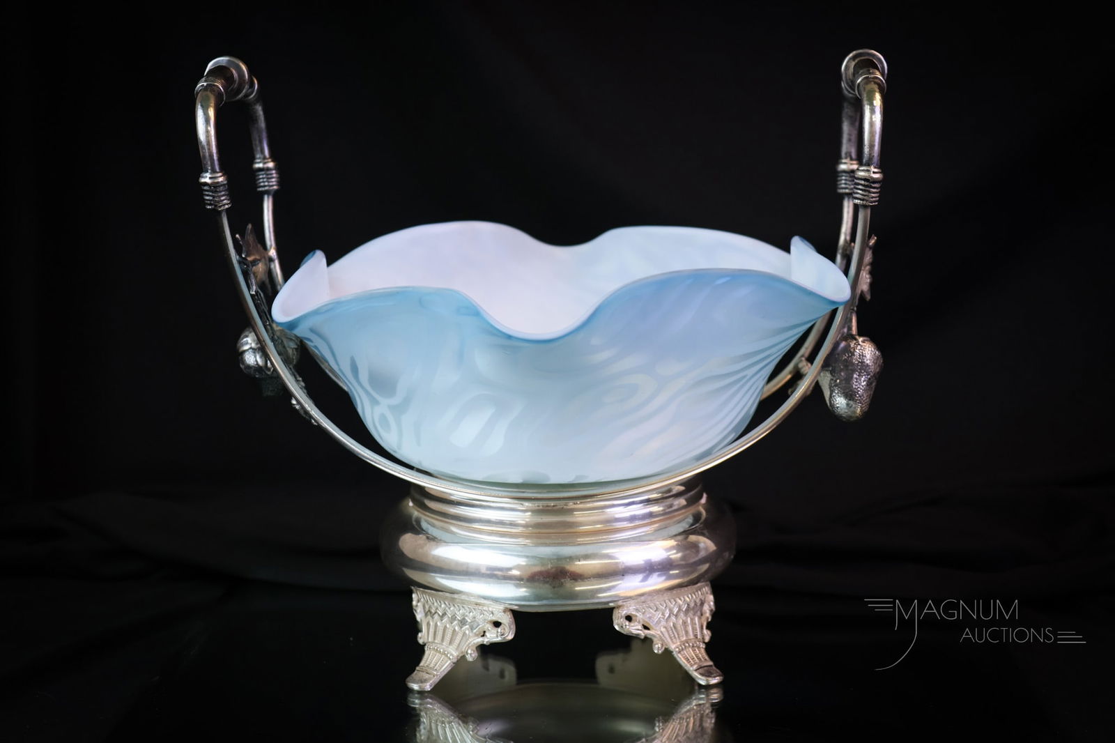 Pairpoint Victorian Silverplate Mother of Pearl Satin Glass Brides Bowl: A beautiful addition for your art glass collection. This is a bride's bowl in blue satin moire mother-of-pearl pattern. The bowl resides in a signed Pairpoint silverplate basket holder with large