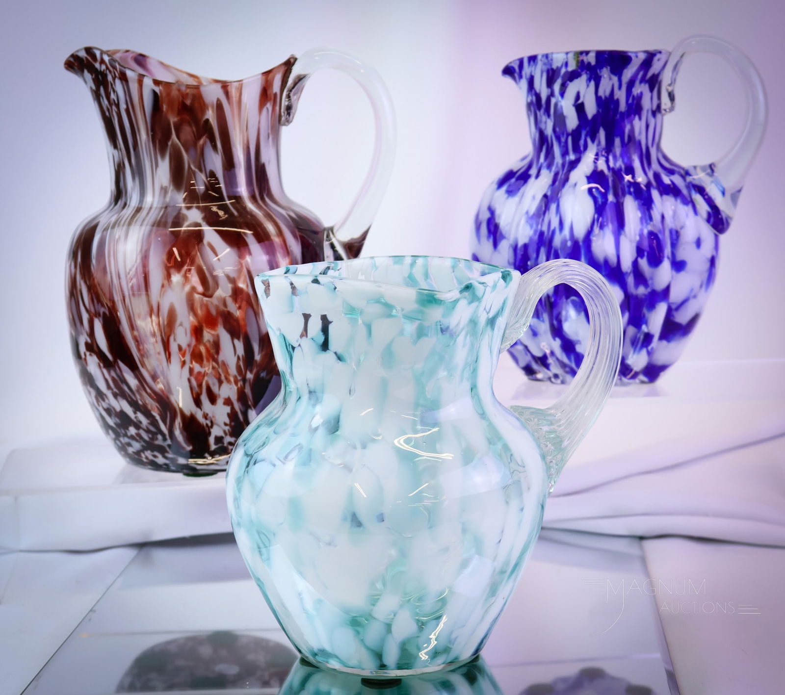 3 pc Lot Victorian Splatter Glass Art Glass Water Pitchers Phoenix & More: Three Victorian splatter glass water pitchers for your bidding pleasure. This lot includes various colors, sizes, and forms. The tallest measures 9 1/4". SHIPPING NOTICE: If you choose not to utilize