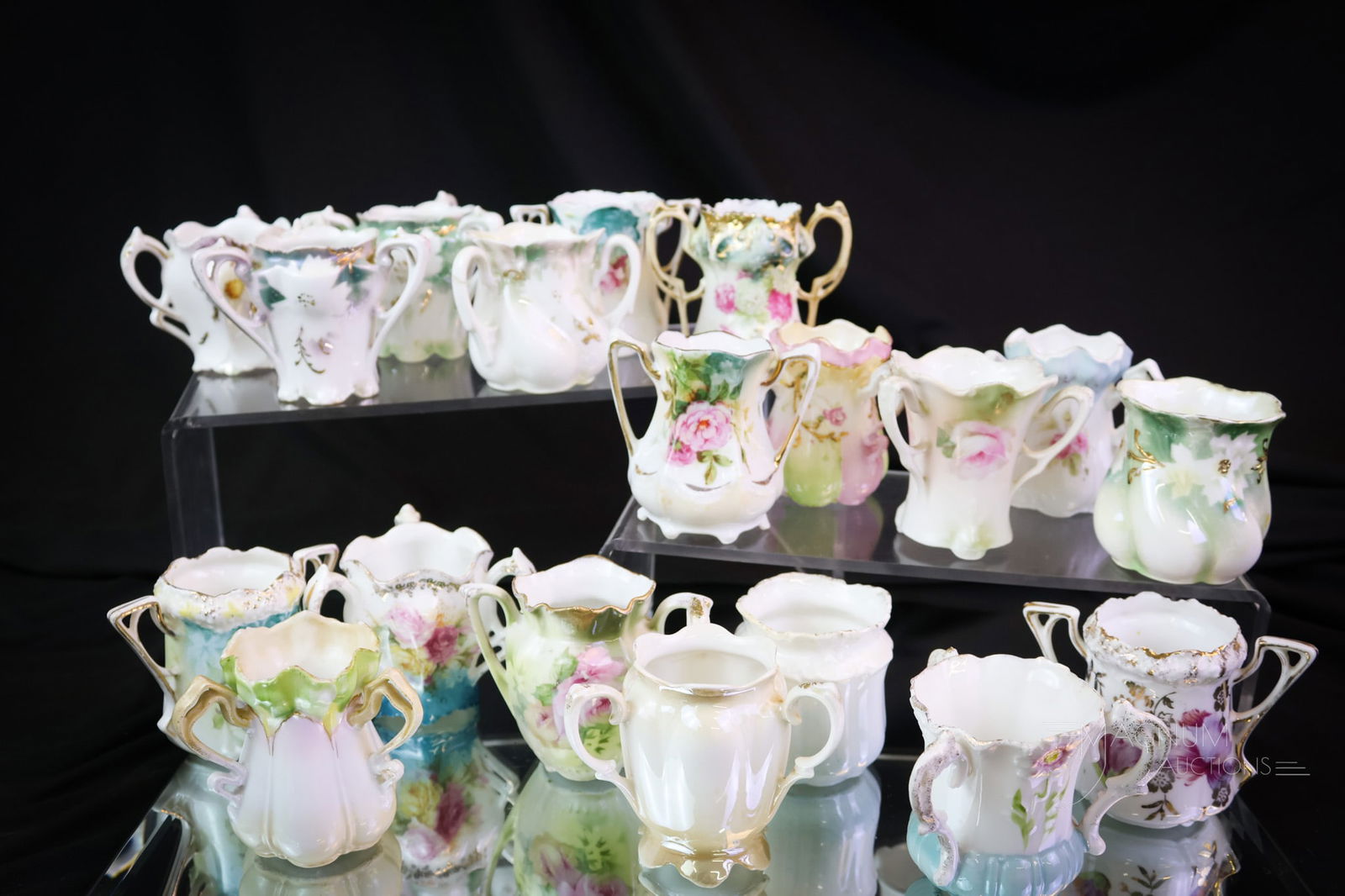 19 pc Lot R.S. Prussia Porcelain Toothpick Holders: Nineteen divine finds in R.S. Prussia porcelain toothpick holders. Eighteen have floral decoration. The 19th has a cottage scene. The tallest measures 2 1/4". Provenance: This item is from the privat