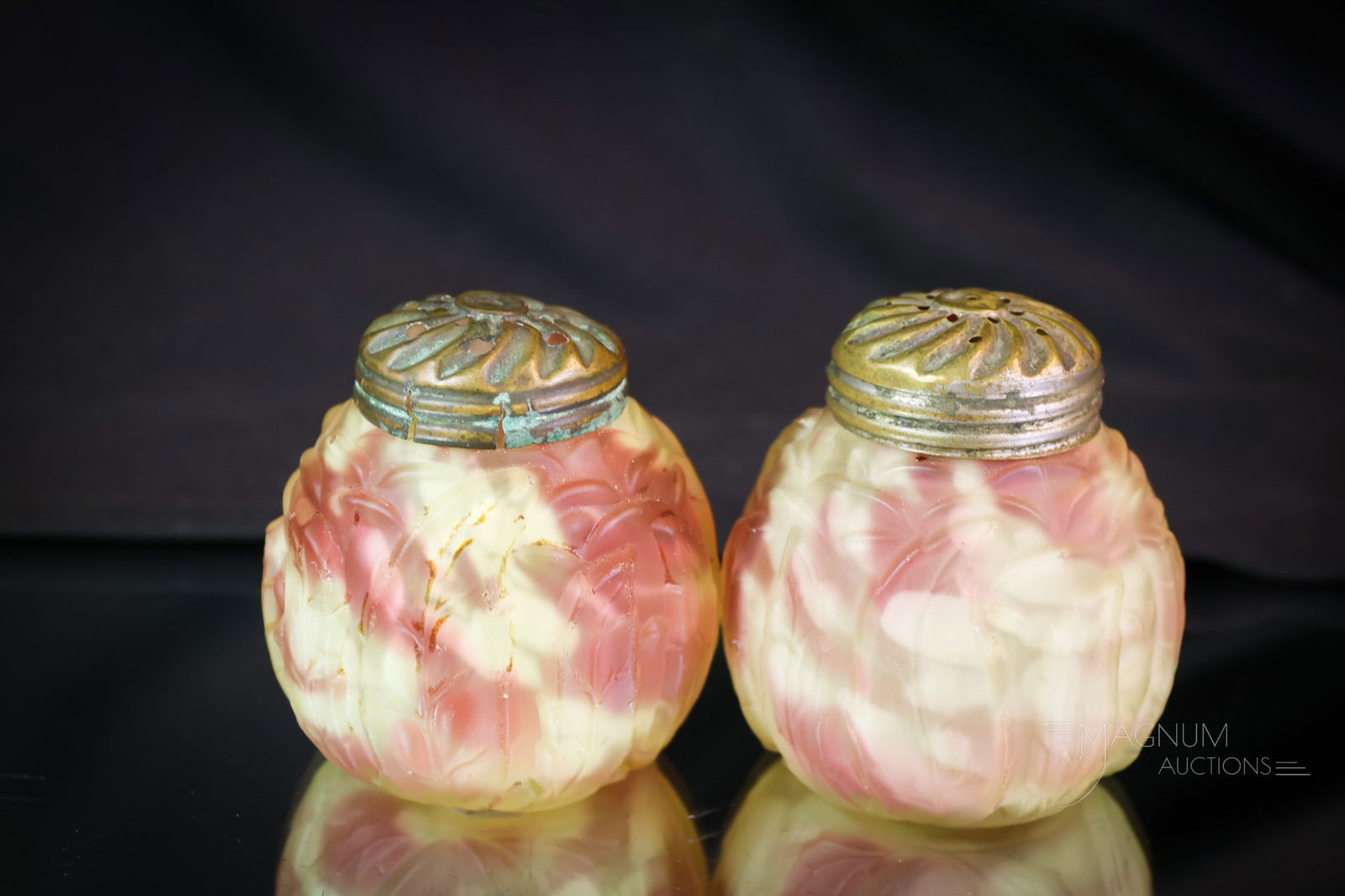 Pair Northwood Uranium Vaseline Cranberry Spatter Leaf Mold Shakers: A fine pair of Northwood Uranium-rich Leaf Mold pattern Victorian shakers. Each is in vaseline cranberry spatter glass. Both light up under black light. Each with the original lids. Each shaker measur