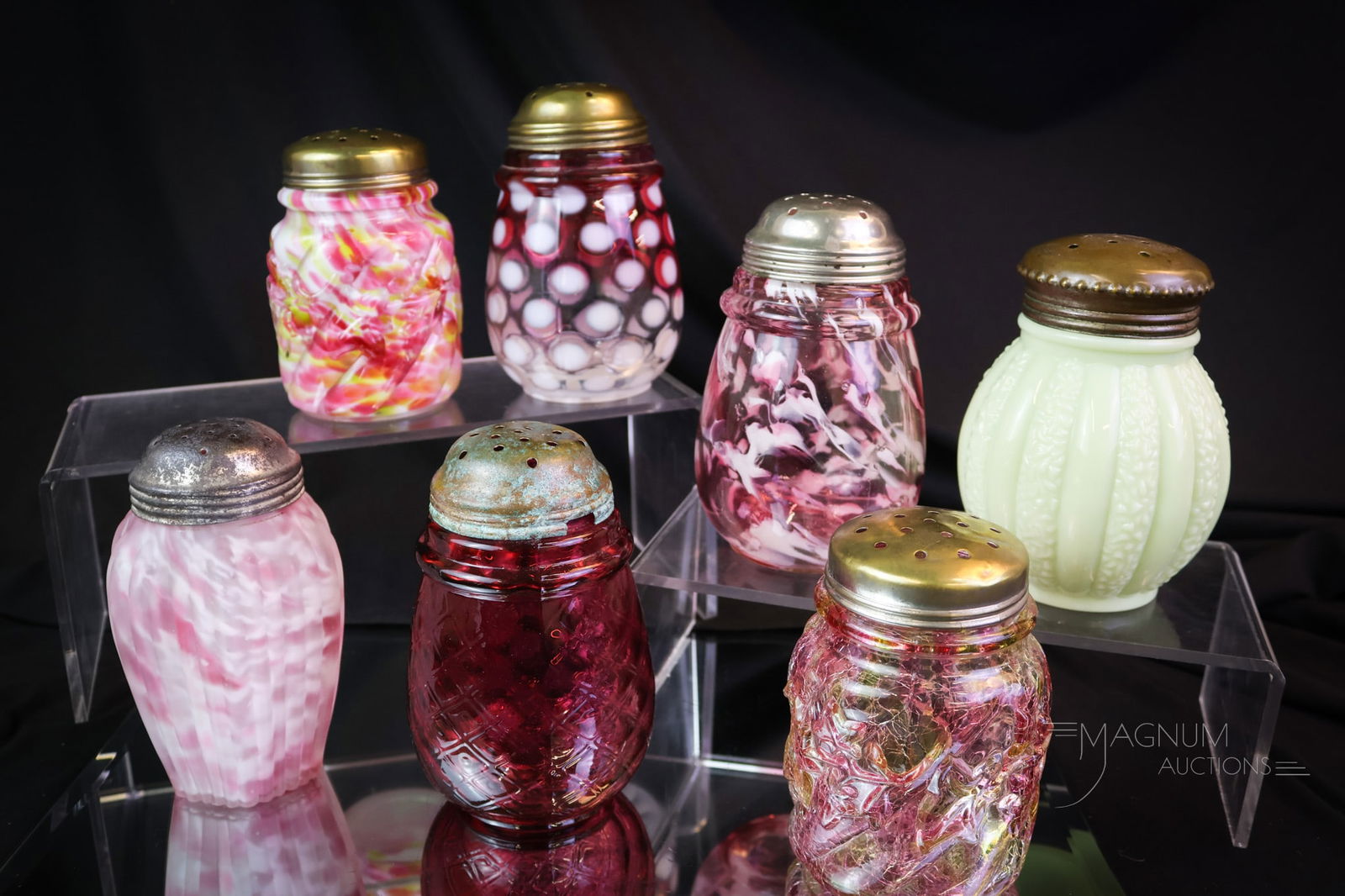 7 pc Lot Victorian Glass Sugar Shakers Northwood & Uranium: Seven collectible Victorian sugar shakers are up for bidding. This lot includes various examples of Northwood glass sugar shakers and oneuranium-rich custard Melligo example. The tallest measures 4 1/