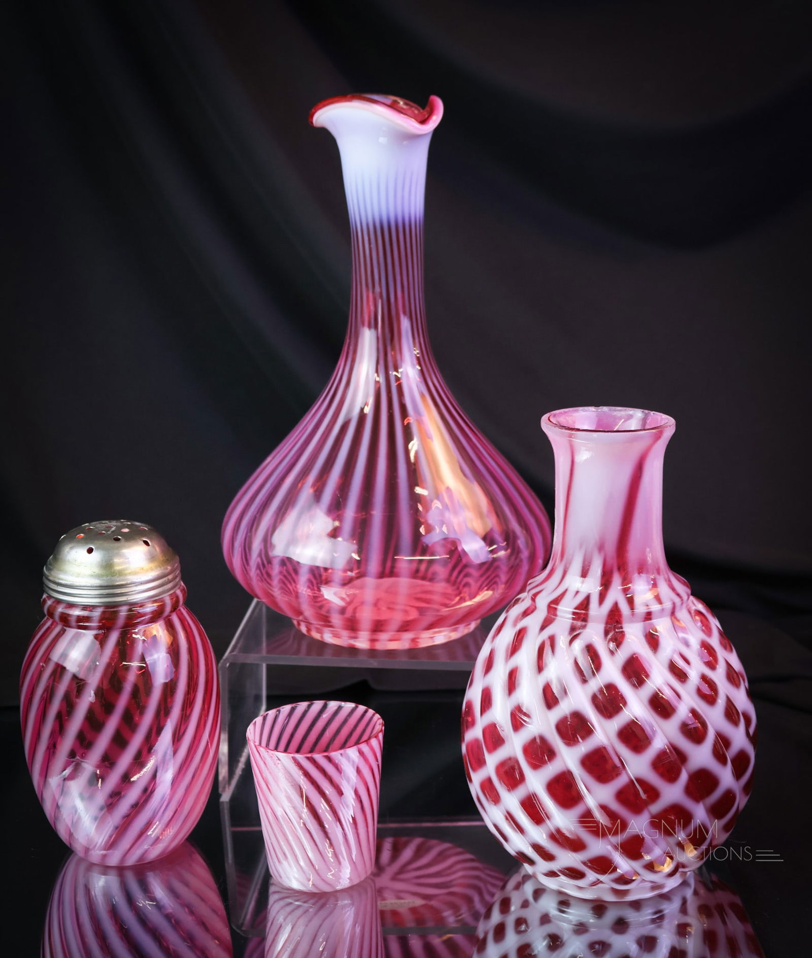 4 pc Lot Cranberry Opalescent Northwood Buckeye Hobbs Victorian Glass: Four very nice finds in Victorian cranberry opalescent glass. This lot offers a Hobbs Swirl pattern sugar shaker. A Northwood Stripe decanterand swirl cordial. The last piece is an undocumented Buckey