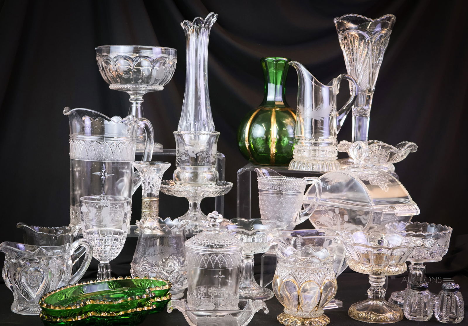 27 pc Lot Early American Pattern Glass Riverside & More: Twenty-seven pieces of early American pattern glass, including some examples of Riverside. This lot is sure to please. There are compotes, vases, bowls, shakers, and moreThe tallest of the offerings m