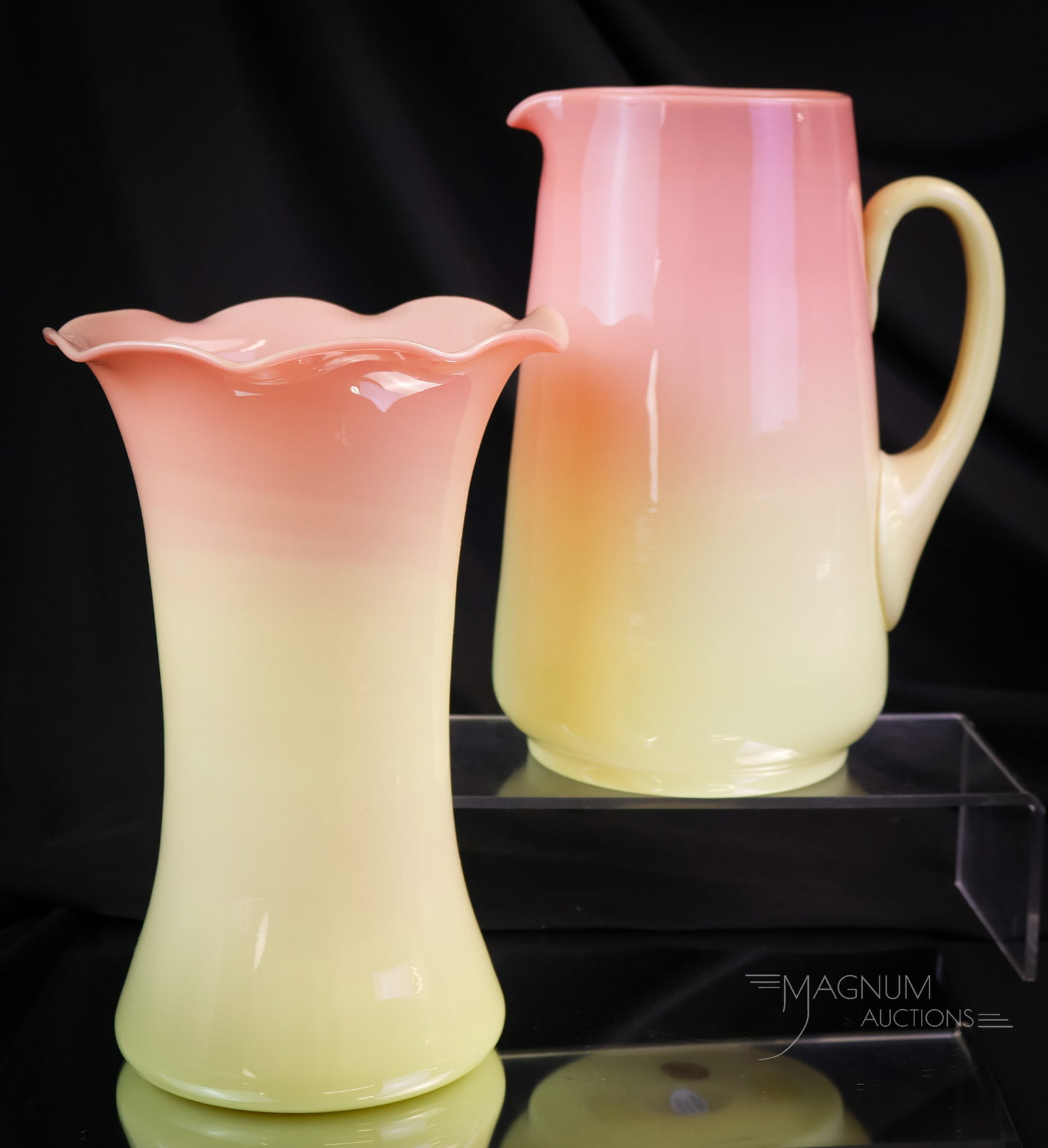 2 pc Lot Mt. Washington Victorian Burmese Art Glass Pitcher & More: Two beautiful piece of glossy Mt. Washington burmese glass. This offering includes a tankard pitcher along with a tall vase. Excellent coloring on both pieces. The tallest measures 9". SHIPPING NOTICE