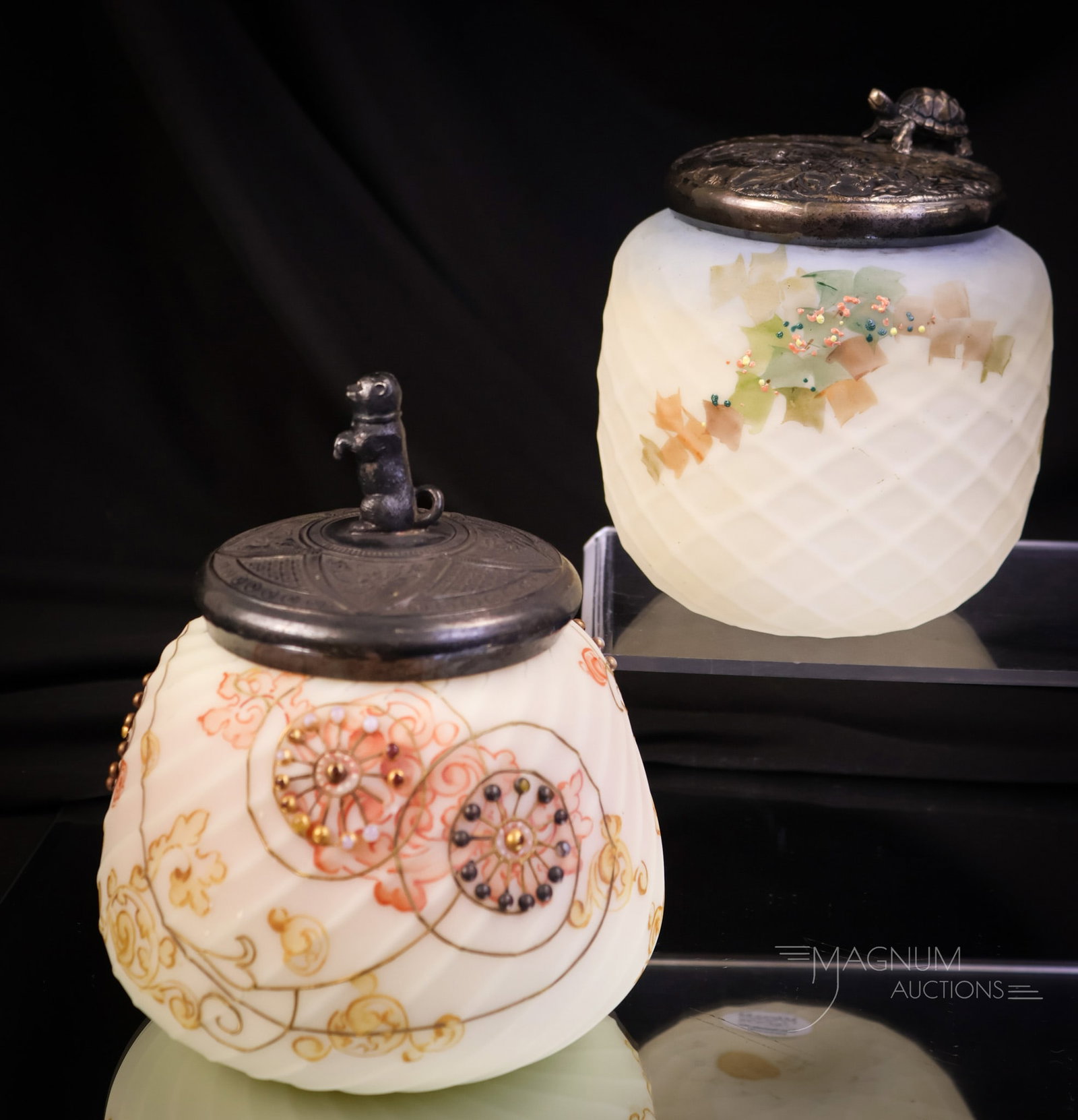 2 pc Lot Mt. Washington Glass Sweetmeat Jars Crown Milano & More: A select offering of two Mt. Washington Victorian glass sweetmeat jars. The first is a signed Crown Milano example with cabochon jewels in the decoration. This jar has a figural dog lid. The second is