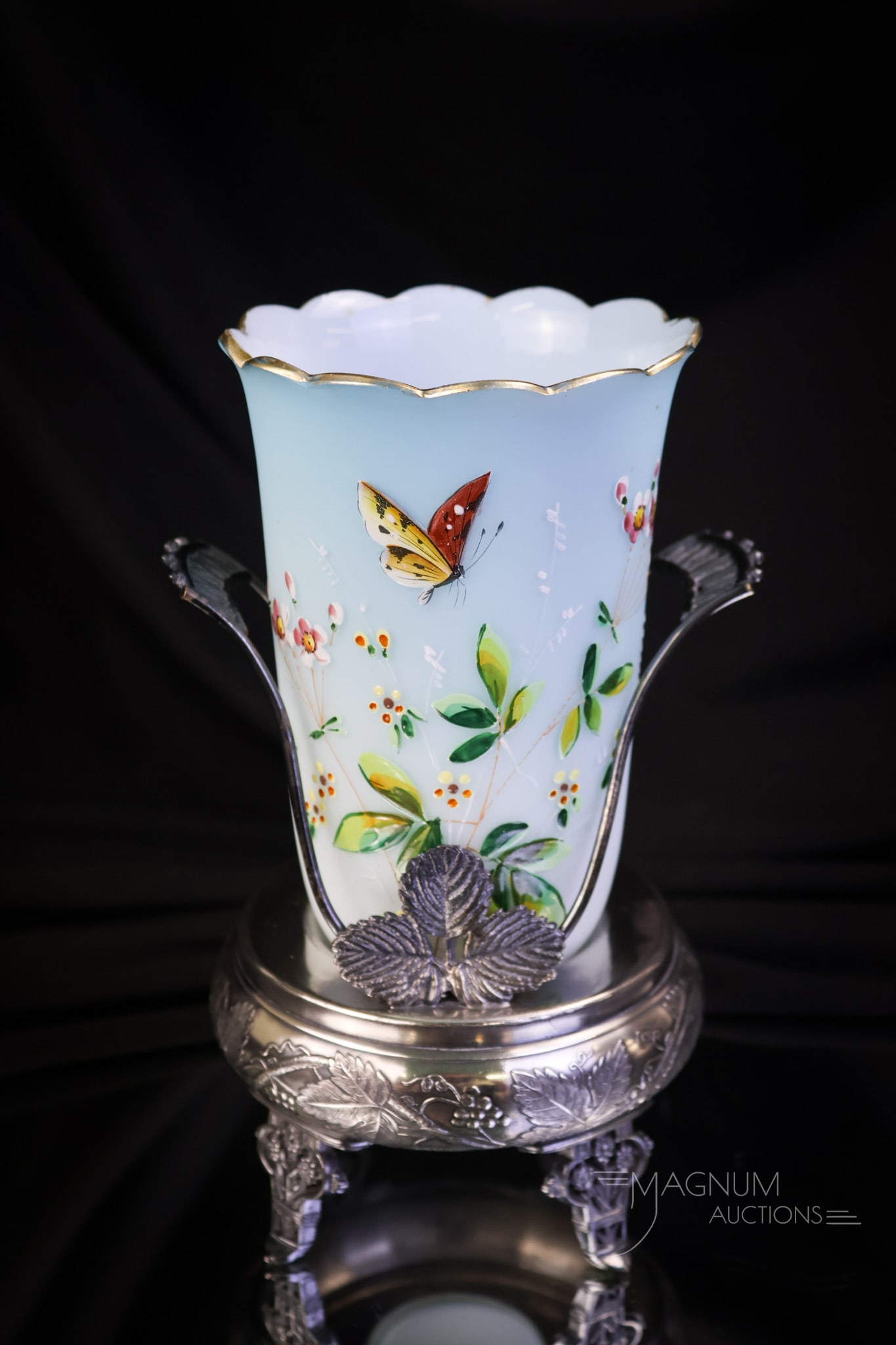 Meriden Silverplate Victorian Enameled Satin Glass Celery Castor: A pale blue satin glass enameled celery vase set in a simeriden silverplate original frame. This celery vase is decorated with flowers, a butterfly, and gold accents. The complete castor measures 7 1/