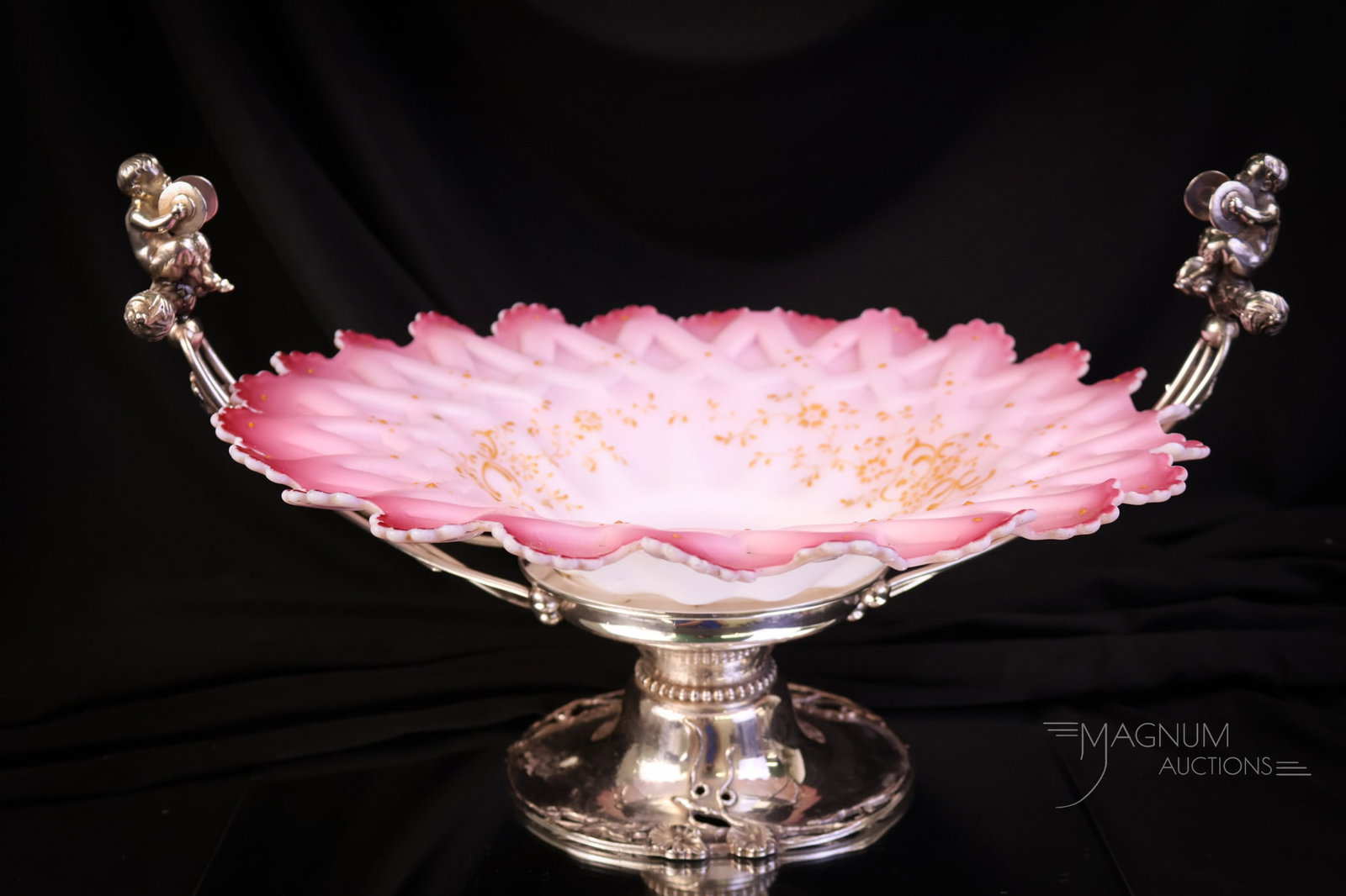 Meriden Silverplate Victorian Pink Enameled Glass Victorian Brides Bowl Centerpiece: A gorgeous find in a marked Meriden silverplate Victorian Brides bowl centerpiece. This holder cradles a pink satin sawtooth rim bowl with enameled decoration. Each arm has puttis holding symbols. The