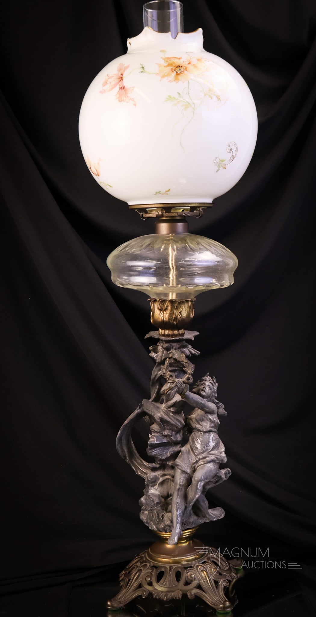 Mt. Washington Colonial Ware Victorian Figural Banquet Oil Lamp: A beautiful find in a Victorian banquet oil lamp. This one comes with a Mt. Washington Colonial Ware decorated shade. The shade has florals around the body. The lamp features a figural stem and a clea