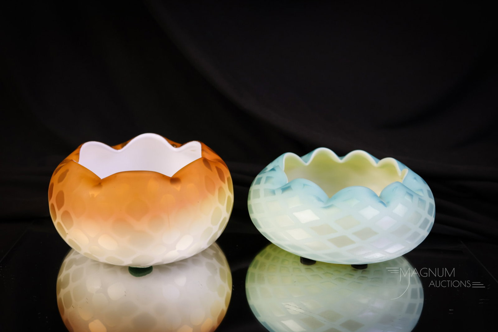 Pair Victorian Mother of Pearl Satin Glass Rose Bowls: A select offering of two Victorian mother-of-pearl satin glass rose bowls. Each is in a diamond quilt pattern. One in blue and one in butterscotch. The latter being marked "Patent." The tallest measur