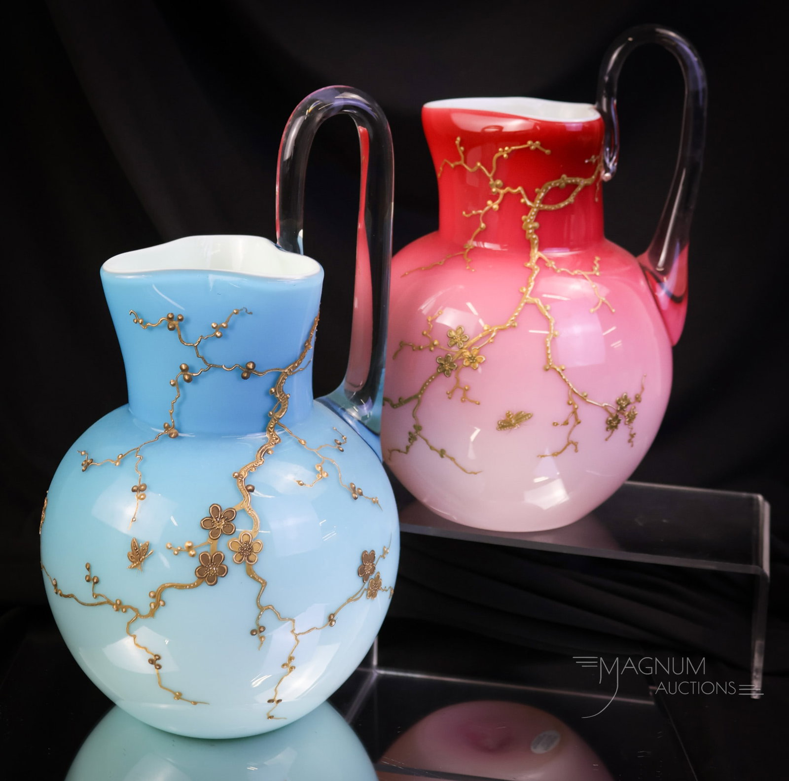 2 pc Lot Signed Harrach High Handle Victorian Art Glass Uranium Water Pitchers: Two glowing finds in Victorian high-handle art glass water pitchers by Harrach Glass. Each is marked. The tallest measures 10 3/4". SHIPPING NOTICE: If you choose not to utilize the LiveAuctioneers Li