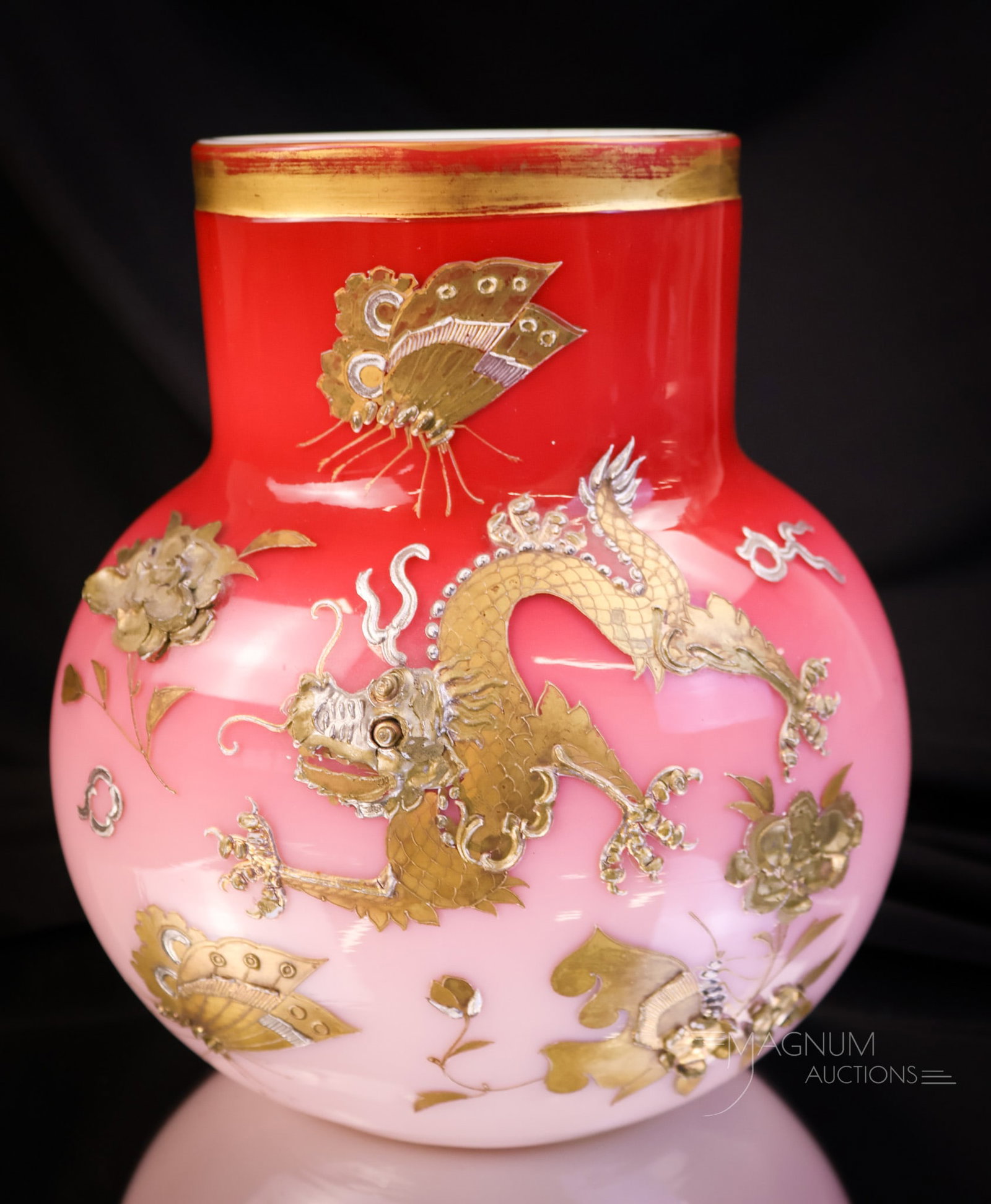 Harrach Peachblow Dragon Gilt Enameled Victorian Glass Vase: A phenomenal find attributed to Harrach Glass. This Victorian peachblow cased vase is elaborately decorated with built-up décor of a dragon, flowers, and a butterfly. The glass is rich in uranium and