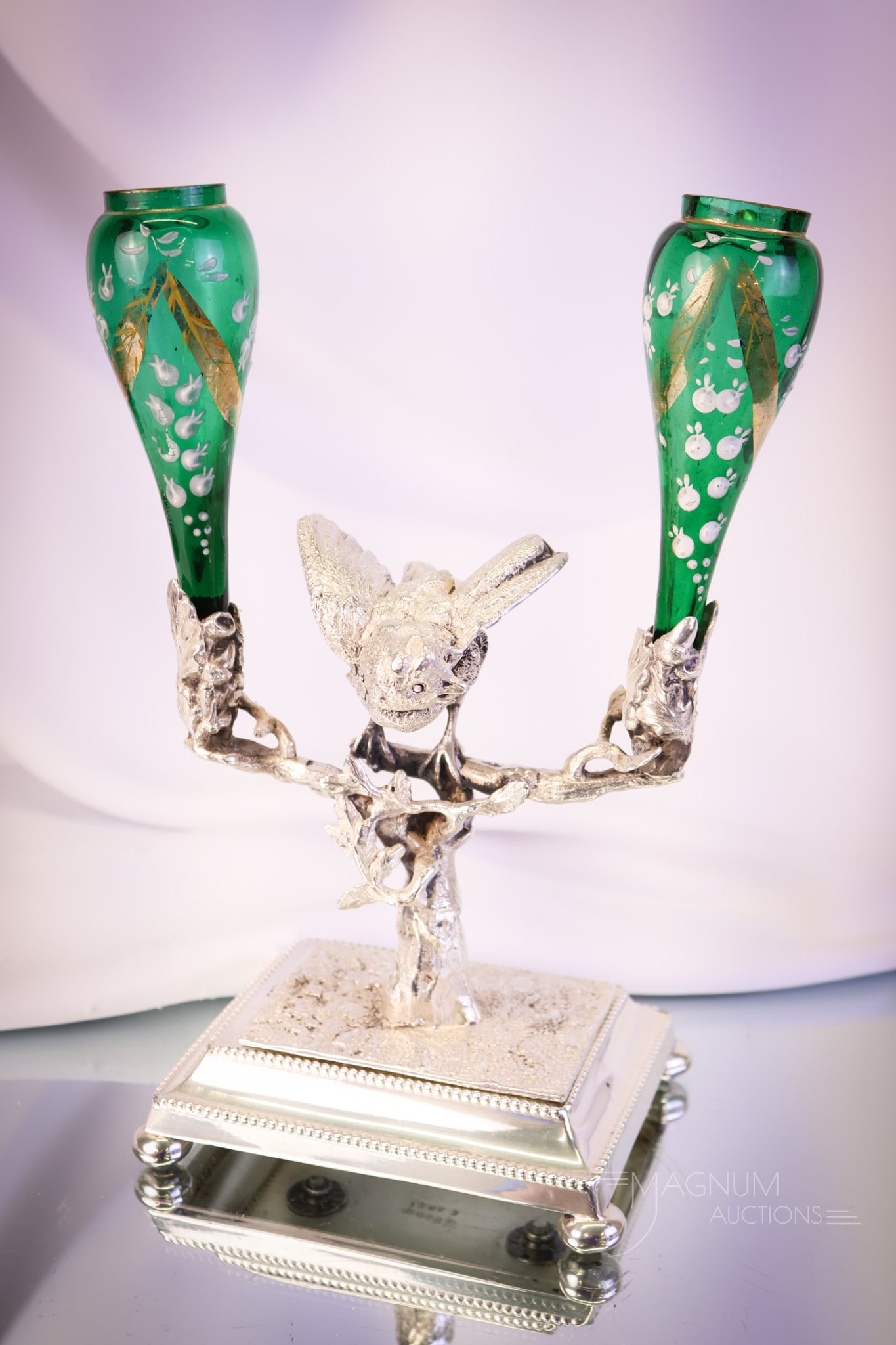 Victorian Emerald Green Enameled English Silverplate Figural Bird Bud Vase: A wonderful piece of Victorian silverplate and decorated glass. This piece is an English hallmarked figural holder featuring a chickadee on a branch that holds two decorated emerald green glass bud va