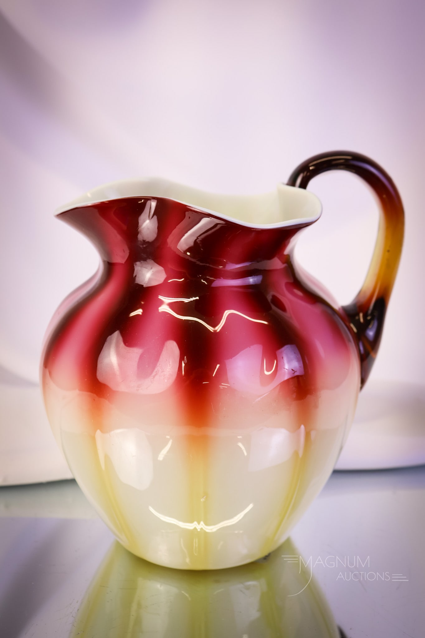 Victorian New England Glass Plated Amberina Water Pitcher: Another striking piece of beauty in our auction. This is a New England Plated Amberina Victorian glass water pitcher. This piece has exceptional coloring. The pitcher measures 7" tall and 6" wide. SHI