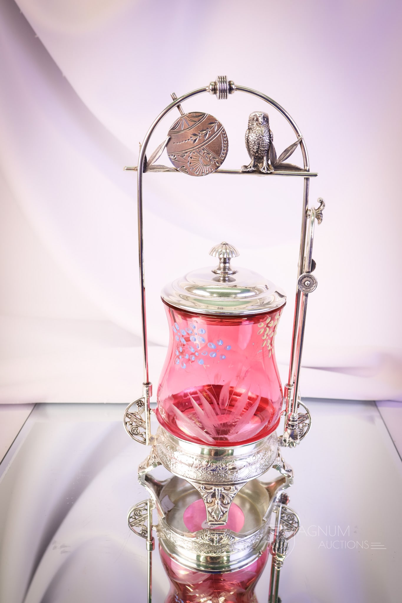 Derby Silverplate Owl & Fan Cranberry Enameled Victorian Glass Pickle Castor: A beautiful and quintessentially Victorian piece. This marked Derby silverplate pickle castor features an owl and an oriental fan perched on the top of the frame. The frame holds a cranberry enameled 