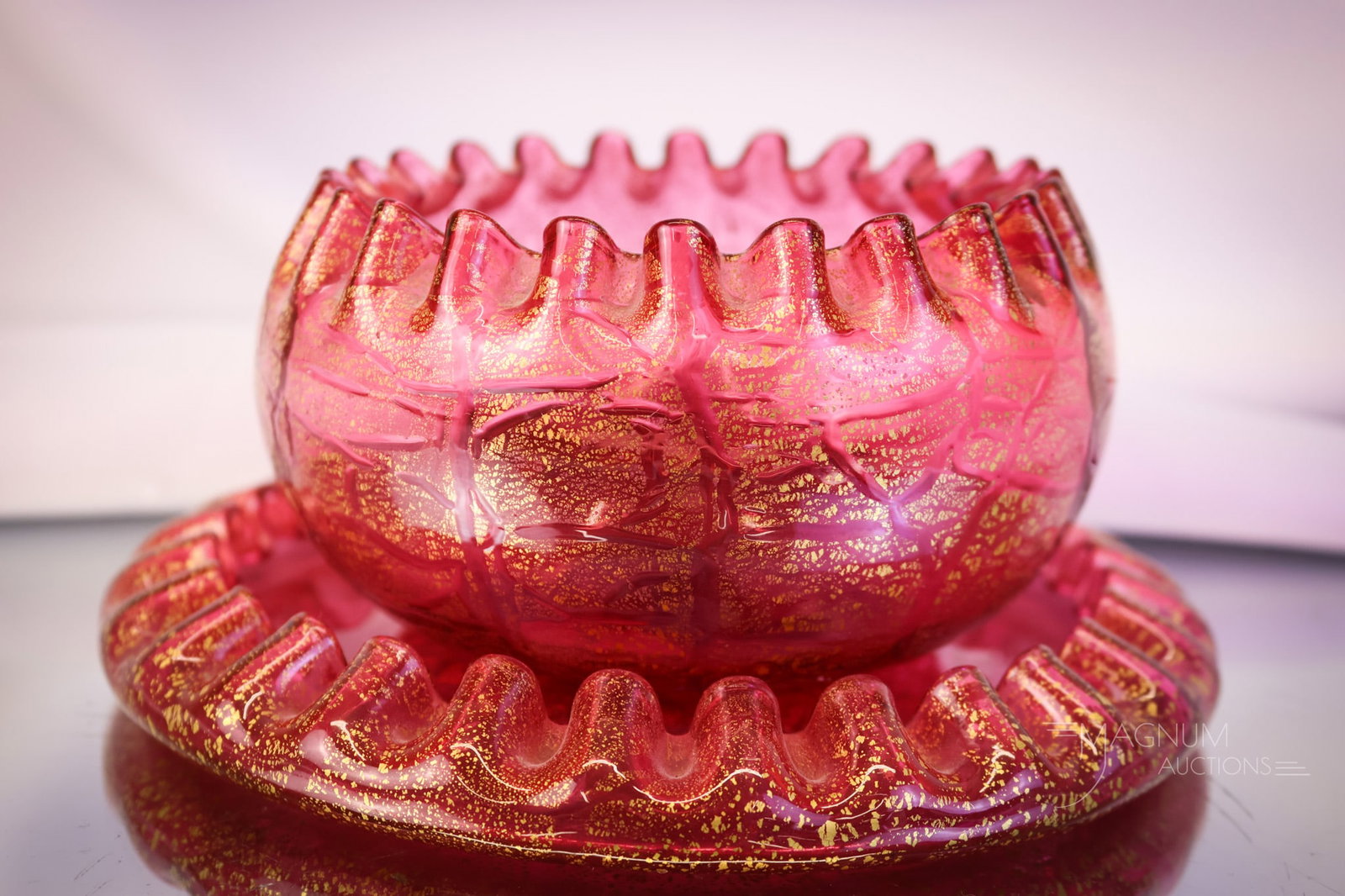 Stevens & Williams Victorian Arabesque Aventurine Finger Bowl & Underplate: A beautiful attributed to Stevens & Williams finger bowl and underplate. This set in an Arabesque aventurine glass in cranberry with gold. The set measures 2 3/4" tall and 6" wide. SHIPPING NOTICE: If