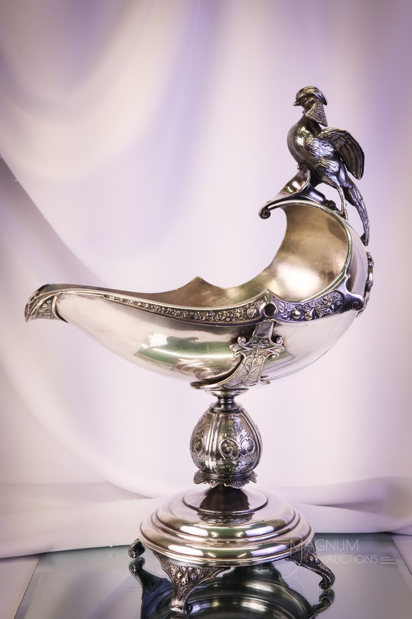Middletown Victorian Silverplate Figural Nut Bowl: A wonderful find in marked Middletown Victorian silverplate. This is a large pedestal figural nut bowl. The bowl features a large bird perched on the top. The nut bowl measures 16" tall and 12" wide. 