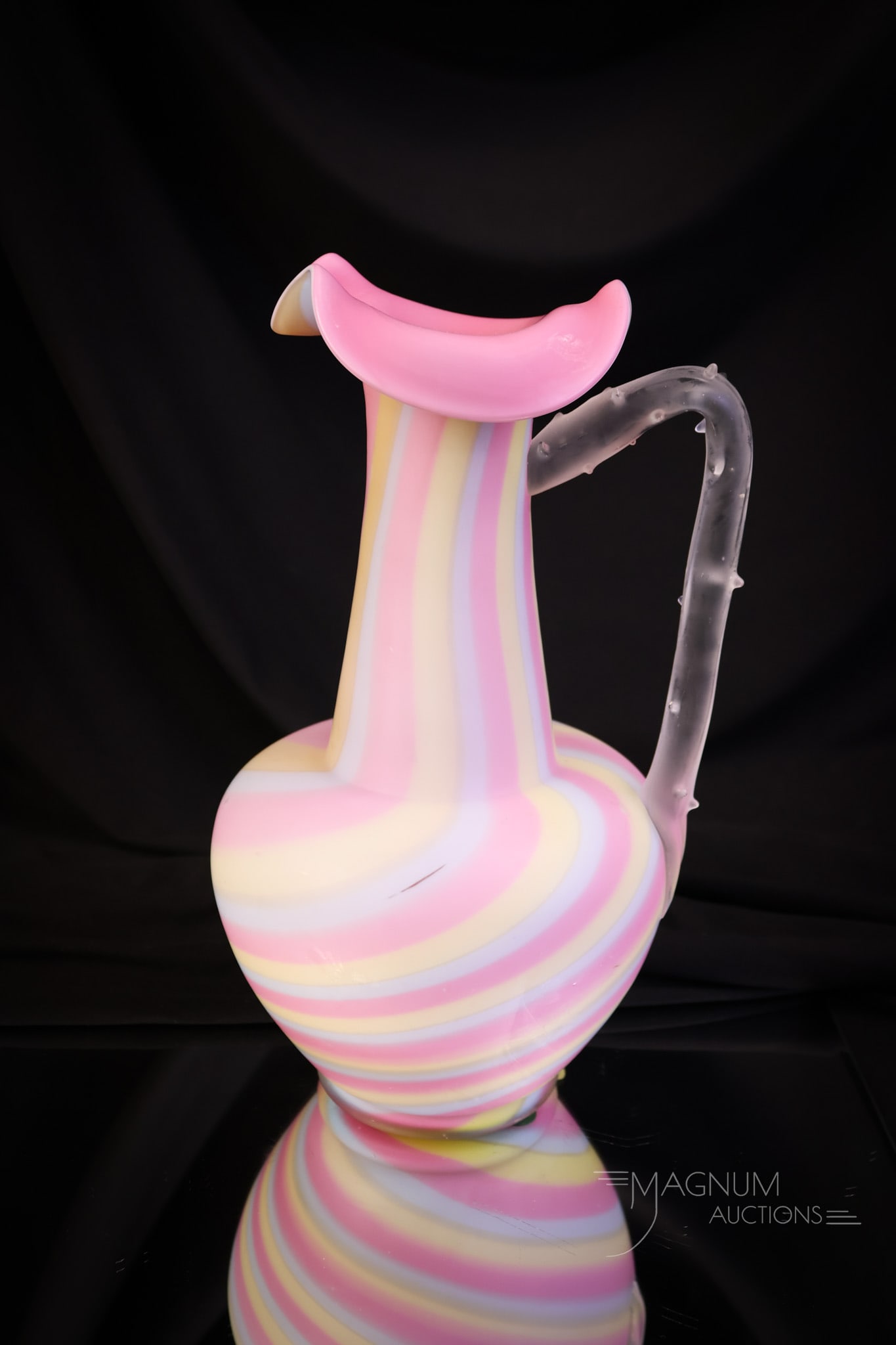Victorian Rainbow Satin Glass Thorn Handle Ewer: Beautiful coloring around the body is found on this rainbow satin glass swirl ewer. The ewer has an applied thorn handle. This fine piece of art glass measures 10" tall and 6" wide. SHIPPING NOTICE: I