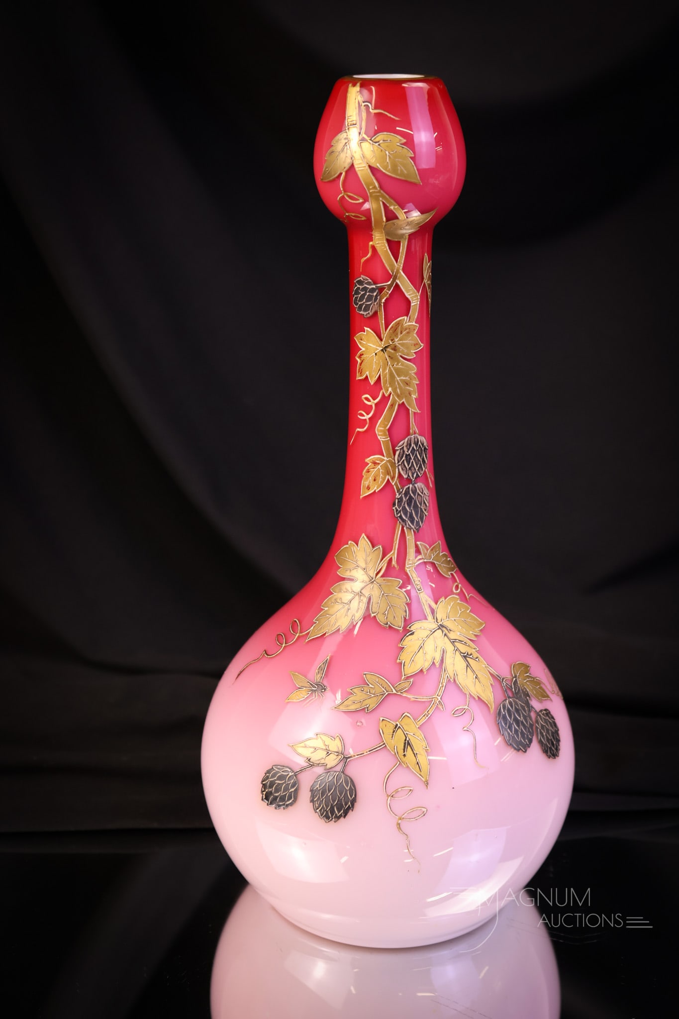 Harrach Peachblow Victorian Gilt Enameled Art Glass Vase: A striking example of a Victorian gilt and enameled art glass vase. This piece is attributed to Harrach. The decoration features a bee amidst the flowers. The vase measures 10 1/4" tall and 4 1/2" wid