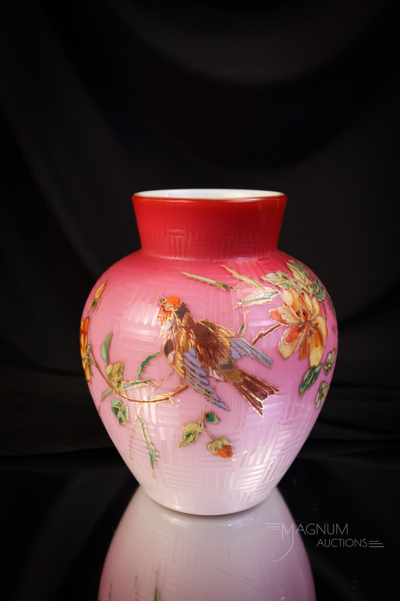 Harrach Peachblow Art Glass Enameled Uranium vase: A great find in a piece of Harrach peachblow enamel decorated glass. This piece features a distinct linear design and flowers and birds in the decoration. The vase is rich in uranium and glows brightl