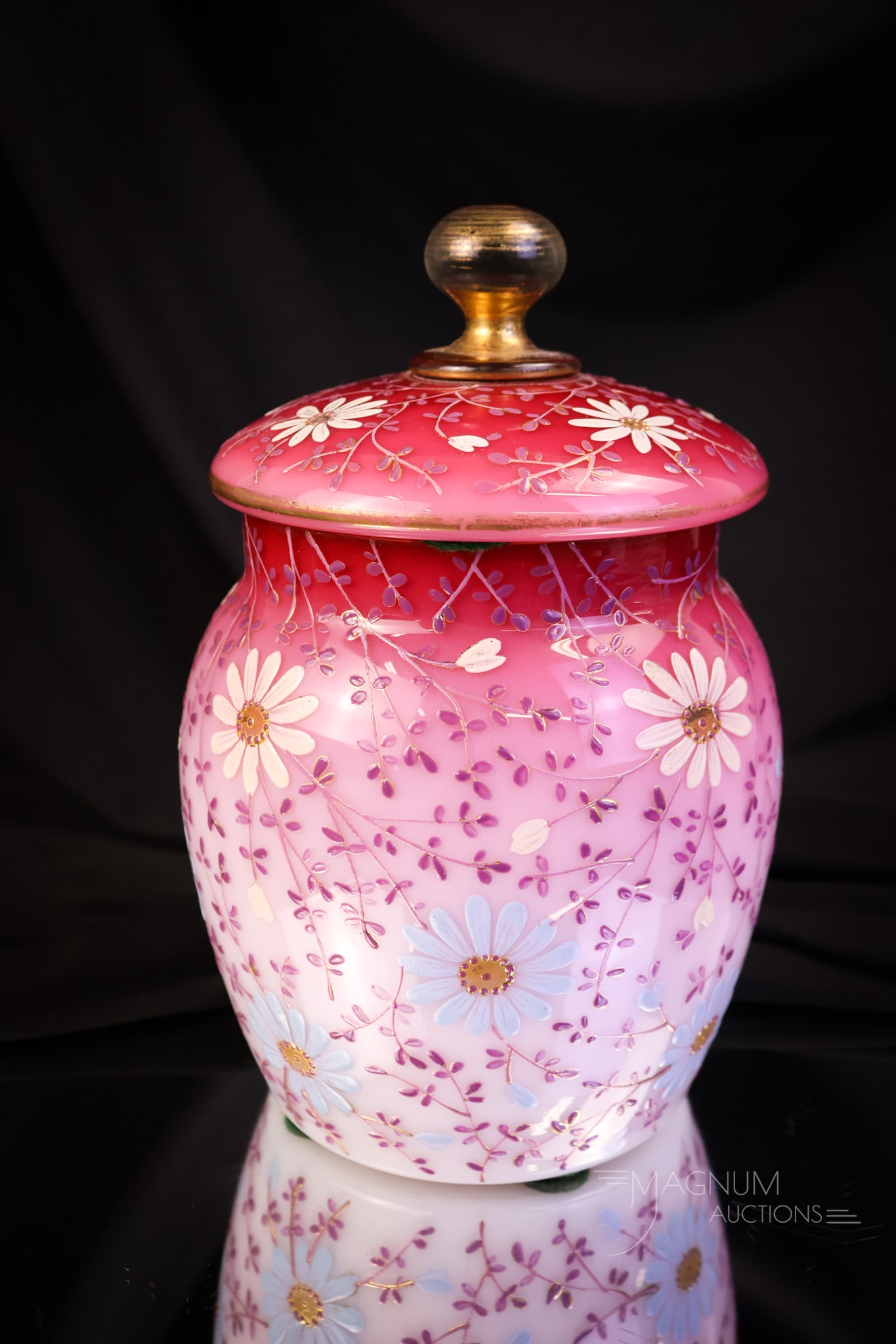 Victorian Peachblow Glass Queen Anne Biscuit Jar: A beautiful find in a Victorian peachblow biscuit jar. This one is decorated with "Queen Anne" decoration of blue and white daisy-like flowers. Gold trim accents this piece further. The biscuit jar me
