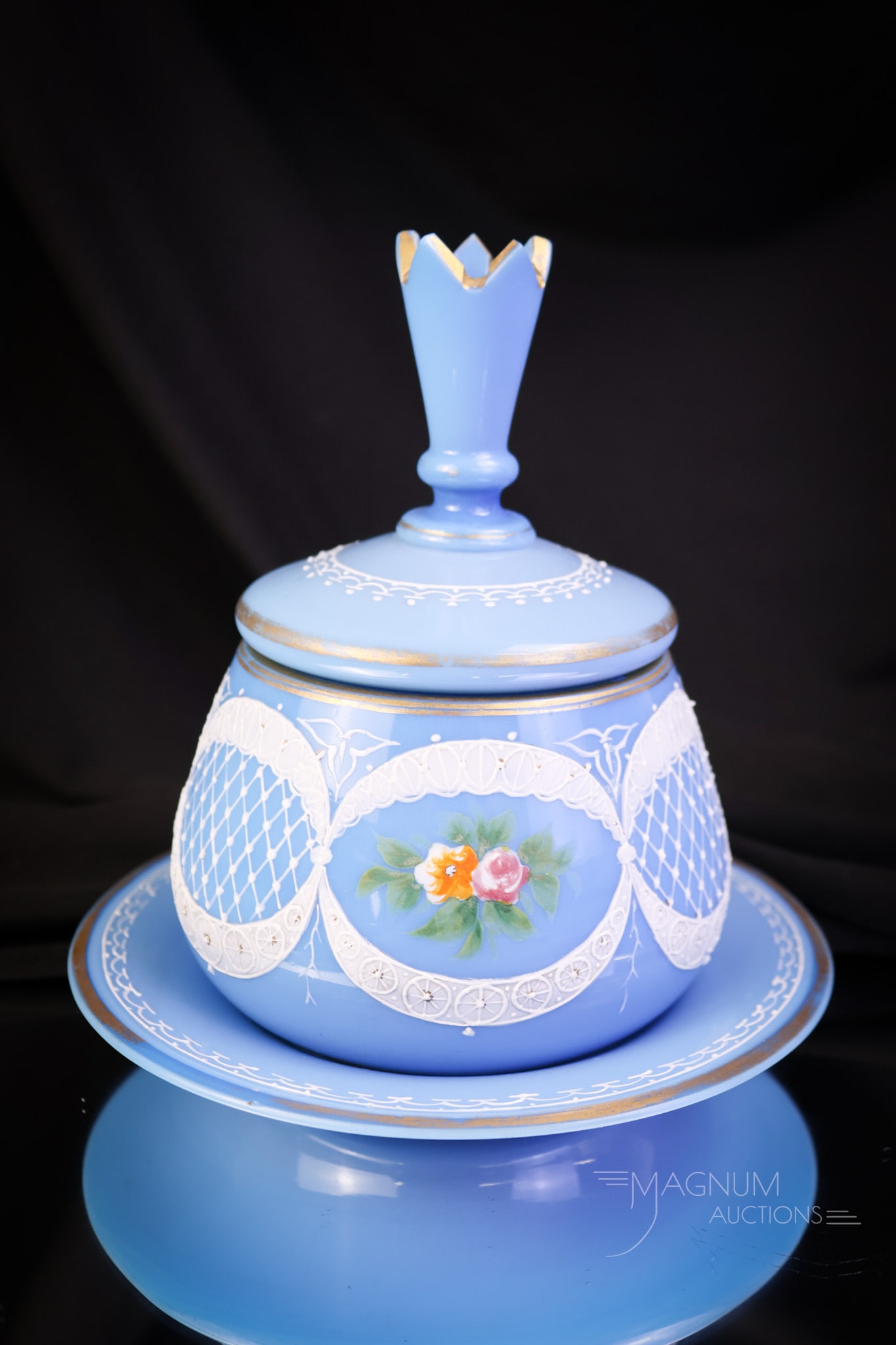 Victorian Enameled Glass Covered Dresser Jar & Pin Tray: A Victorian enameled and gilt glass covered dresser jar and matching pin tray. This beautiful piece is in blue opaque glass. Both pieces feature intricate decoration of white lace and flowers. The lid