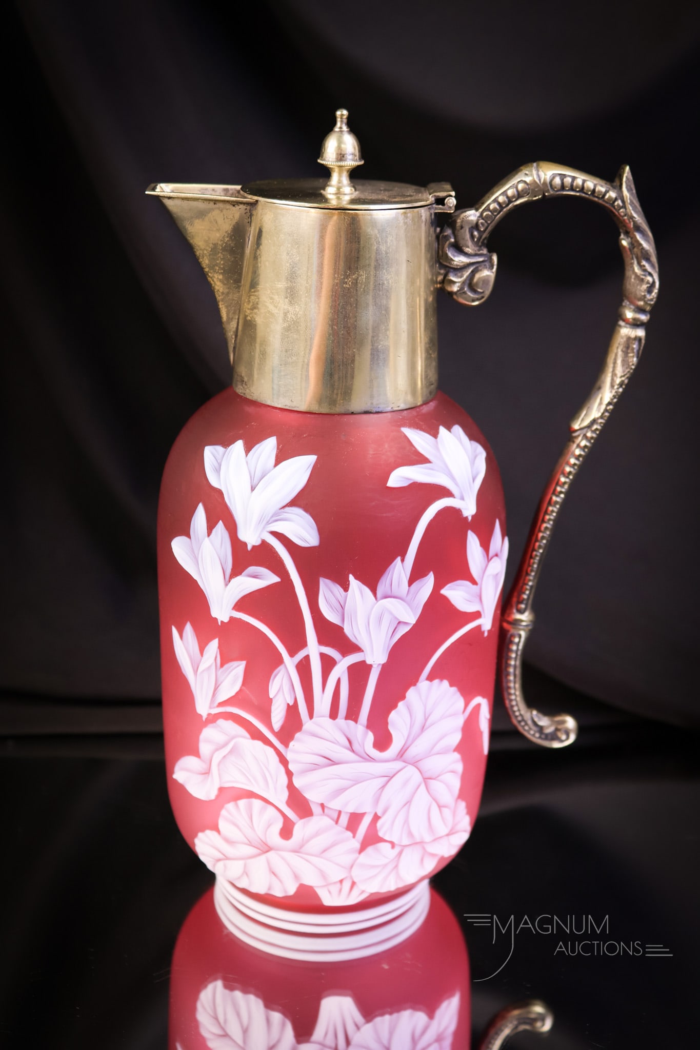 Victorian English Cameo Art Glass Cyclamen Cranberry Claret Jug: A beautiful find in a piece of Victorian English cameo glass. This piece is attributed to Webb. It is masterfully cut from white to cranberry. The claret features a decoration of a cyclamen plant. It 