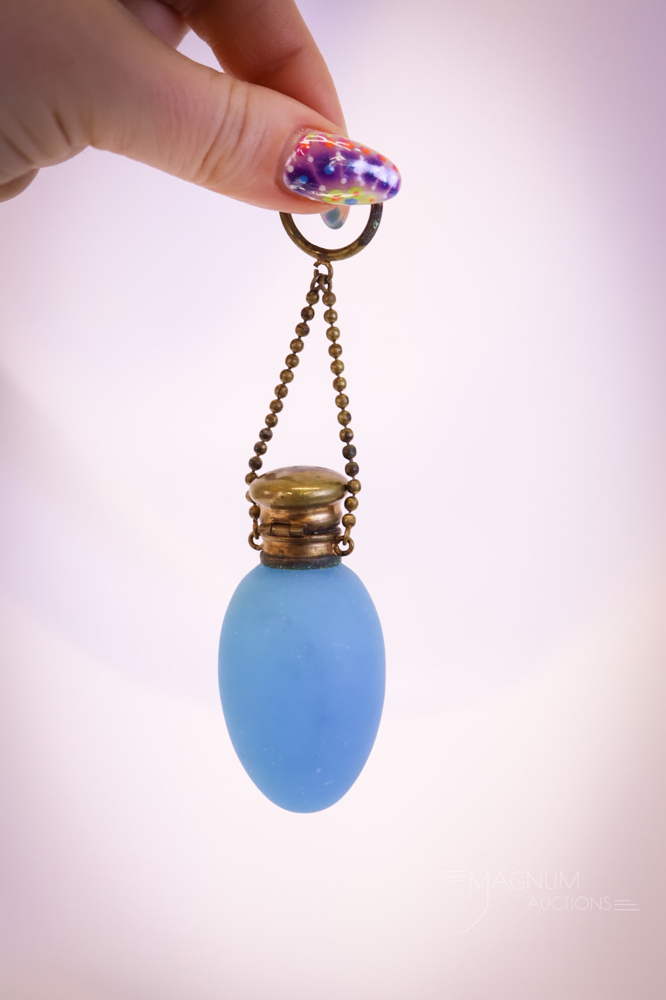 Blue Opaline Glass Grand Tour Teardrop Perfume Bottle w/ Finger Ring: A blue opaline glass Grand Tour teardrop-shaped perfume bottle. This piece retains the original stopper and is fitted with a chain and ring for the finger. This piece measures 2 1/2" tall and 1 1/4" w