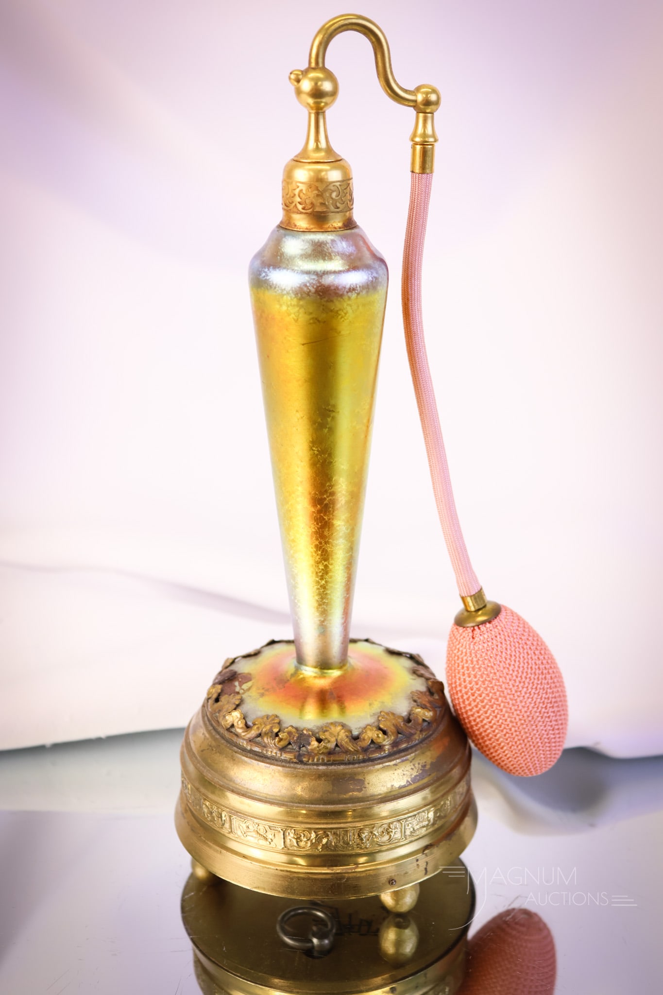 Very Rare Steuben Gold Aurene Glass Musix Box Perfume Atomizer: A rare find in a piece of Steuben glass. This is an Aurene perfume atomizer in gold with a music box mounting. The glass has wonderful iridescence. The music box appears to be in working order. The pi