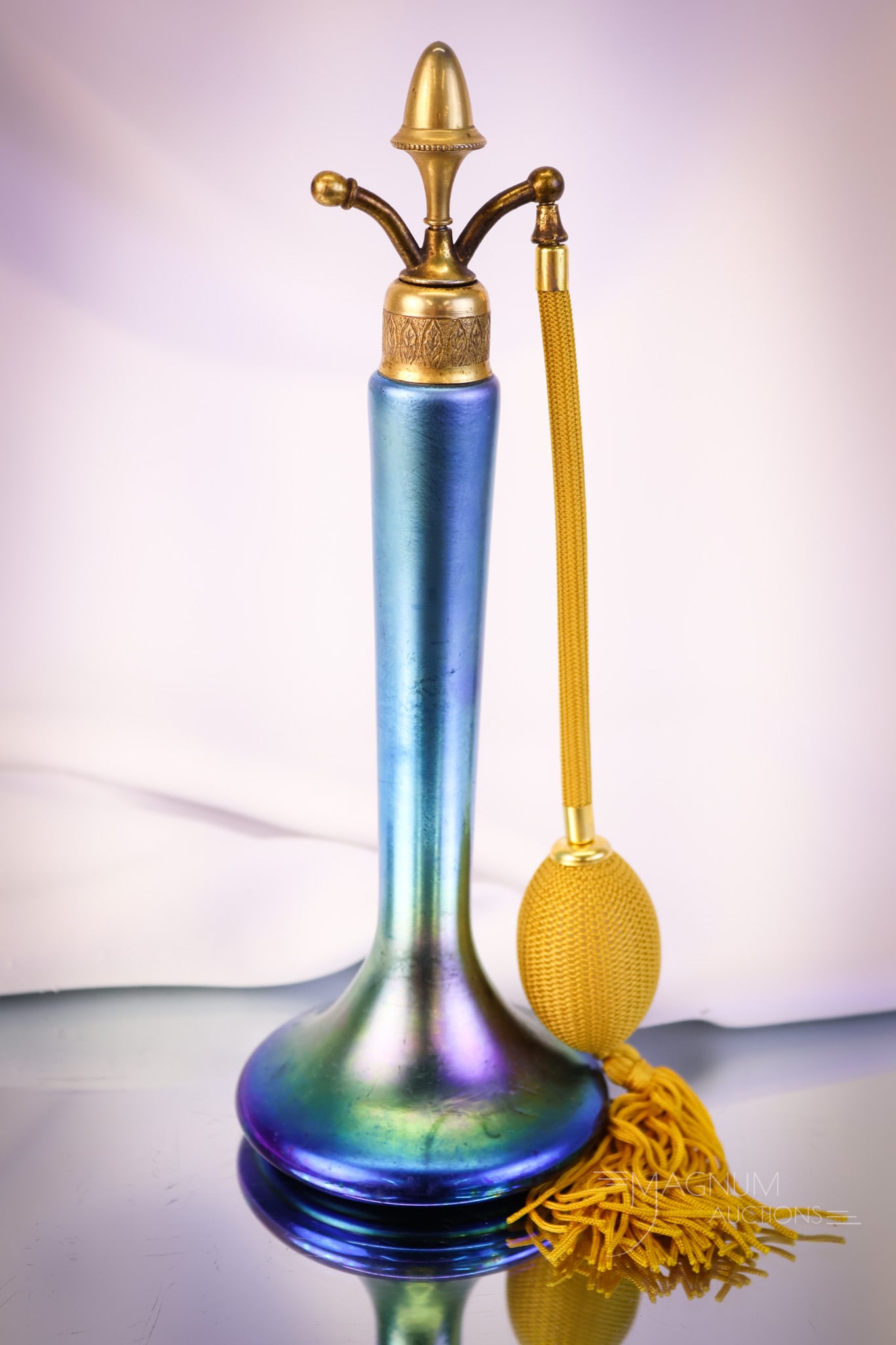 Steuben Blue Aurene Glass Perfume Atomizer: Another selection for your bidding pleasure. This is a blue Aurene Steuben perfume atomizer. This piece has gorgeous coloring and iridescence. The perfume measures 10" tall and 3 1/2" wide. SHIPPING N