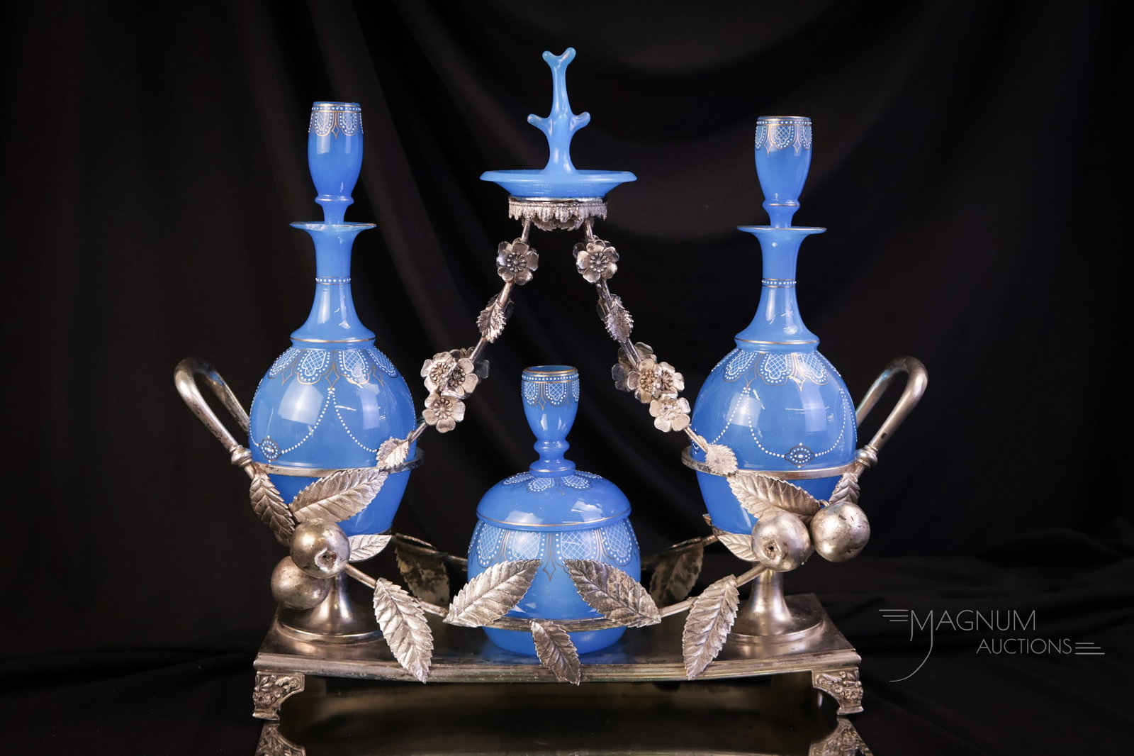 Rare Victorian Meriden Silverplate Blue Opaline Victorian Perfume Vantiy Cologne Bottle Castor Set: A rare offering in marked Meriden silverplate from the Victorian era. This is a complete perfume, cologne bottle, vanity castor set. This piece features an extremely ornate holder with figural apples 