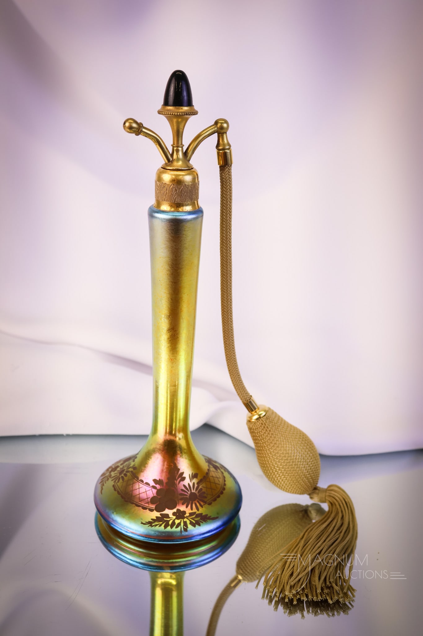 Devilbiss Steuben Gold Aurene Intagilo Cut Perfume Atomizer: A beautiful find in an Intaglio cut perfume atomizer by Steauben and Devilbiss. This one in gold with a black jewel on the top. This piece has exceptional iridescence and cutting. The piece measures 9