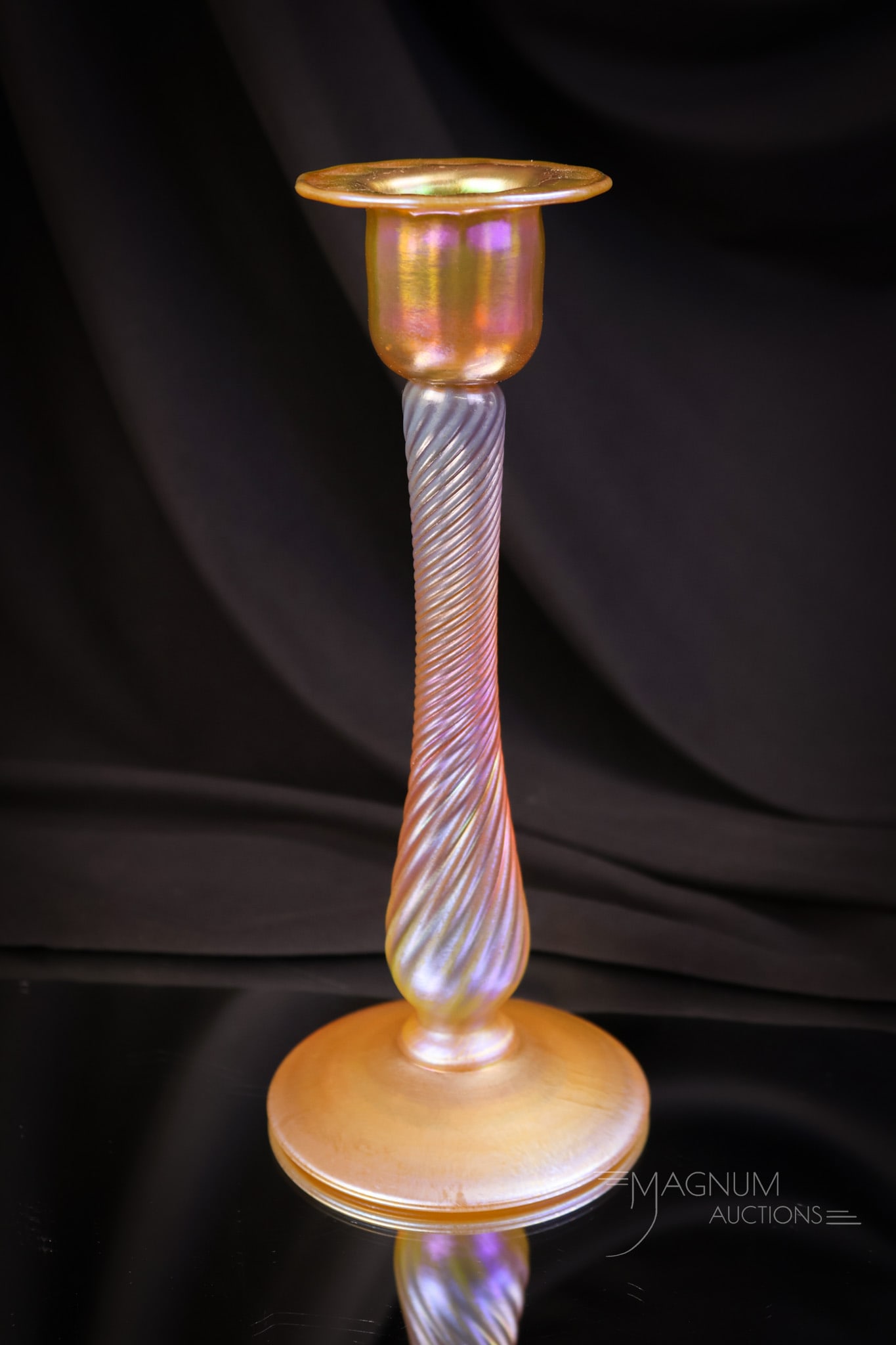 Signed "Nash" Gold Iridescent Art Glass Twist Candlestick: A gem for your collection. This is a gold iridescent art glass candlestick in a twist form. It is signed, "Nash." The stick measures 8 1/2" tall and 3 1/2" wide. SHIPPING NOTICE: If you choose not to