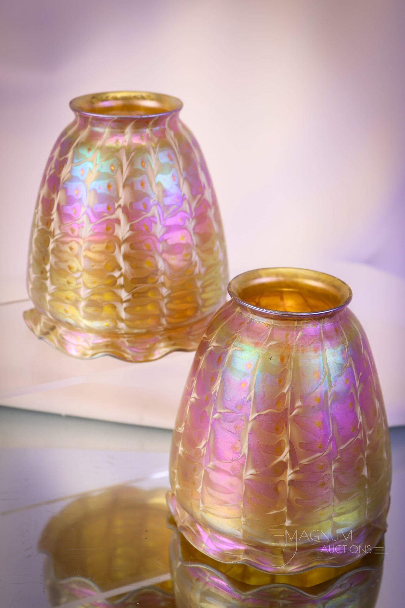 Pair Signed Quezal Golden Electric Iridescent Snakeskin Art Glass Shades: A fine pair of beautiful, signed Quezal art glass iridescent shades. Both are in a snakeskin pattern with an electric, colorful gold iridescence. Each shade measures 4 1/2" tall and 4 1/4" wide. SHIPP