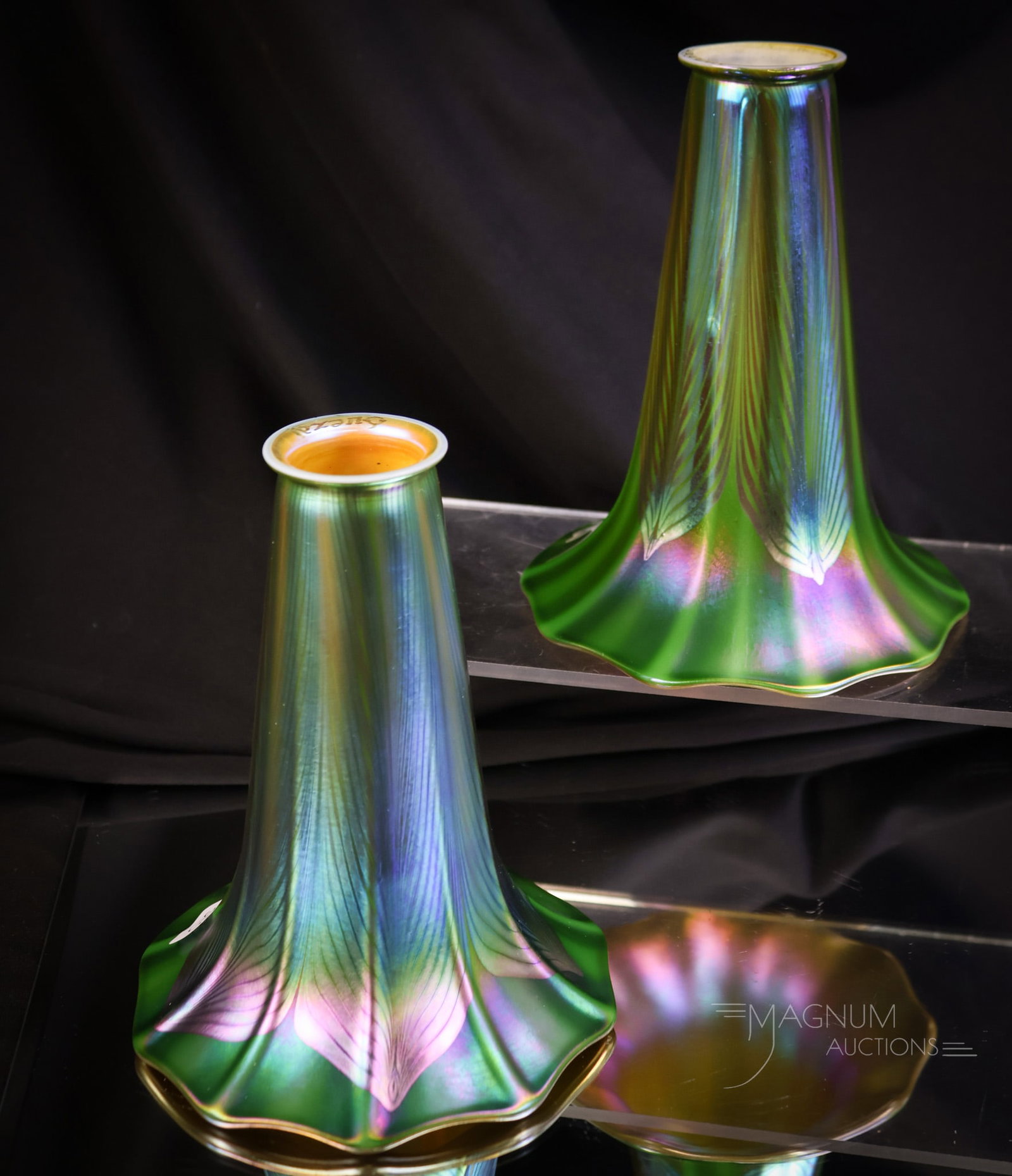 Pair Signed Quezal Vivid Green Pulled Feather Art Glass Iridescent Shades: A fantastic pair of signed Quezal vivid green iridescent art glass pulled feather shades. Each shade has a brilliant orange iridescent interior, too. Both shades measure 5 1/2" tall and 4 1/2" wide,