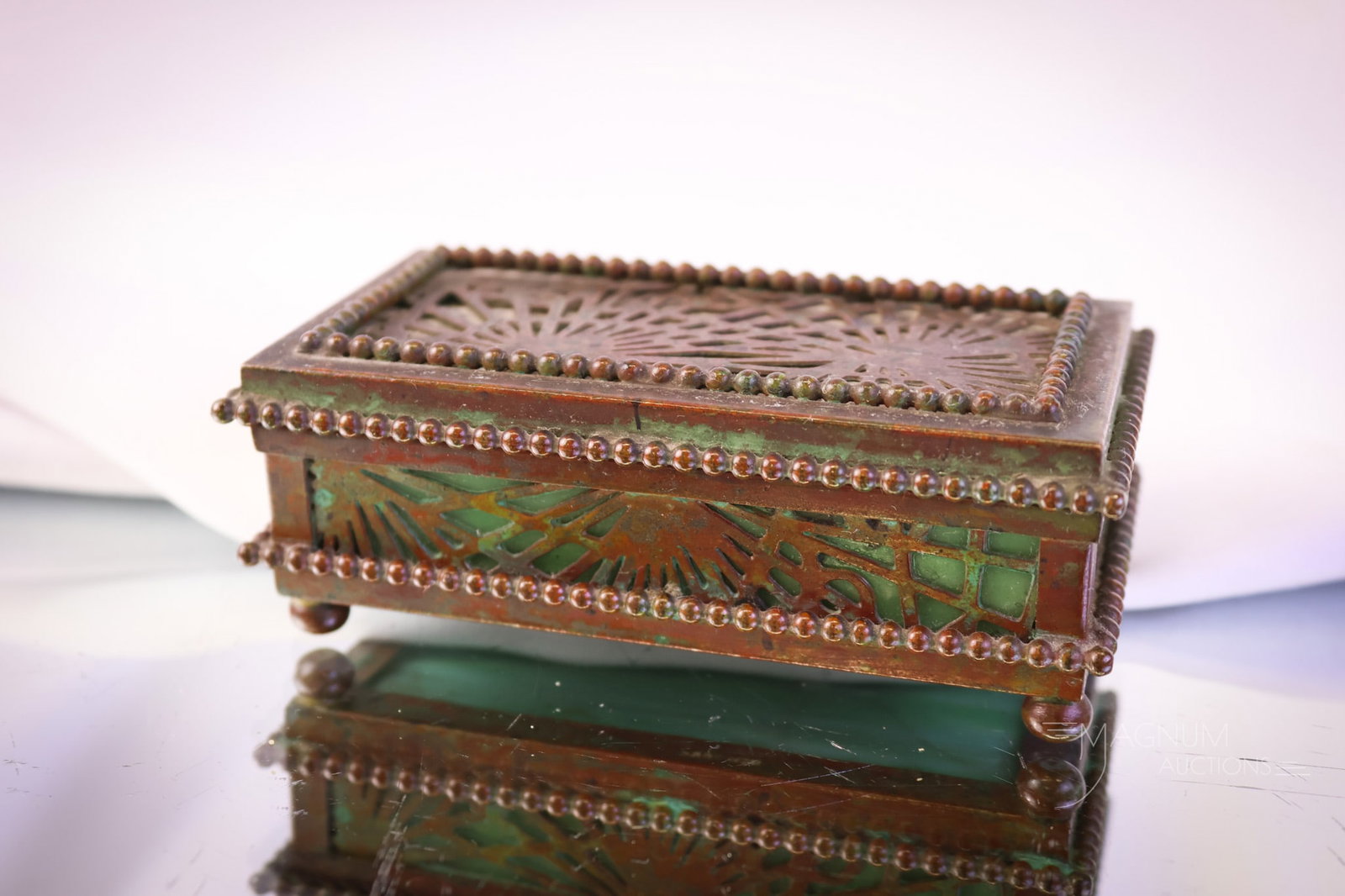 Marked "Tiffany Studios New York 801" Pineneedles Bronze & Slag Glass Stamp Box: Marked "Tiffany Studios New York 801" Pineneedles pattern stamp box. This stamp box is in bronze and green slag glass. The box features the original patina. The piece measures 1 1/4" tall and 4" wide.