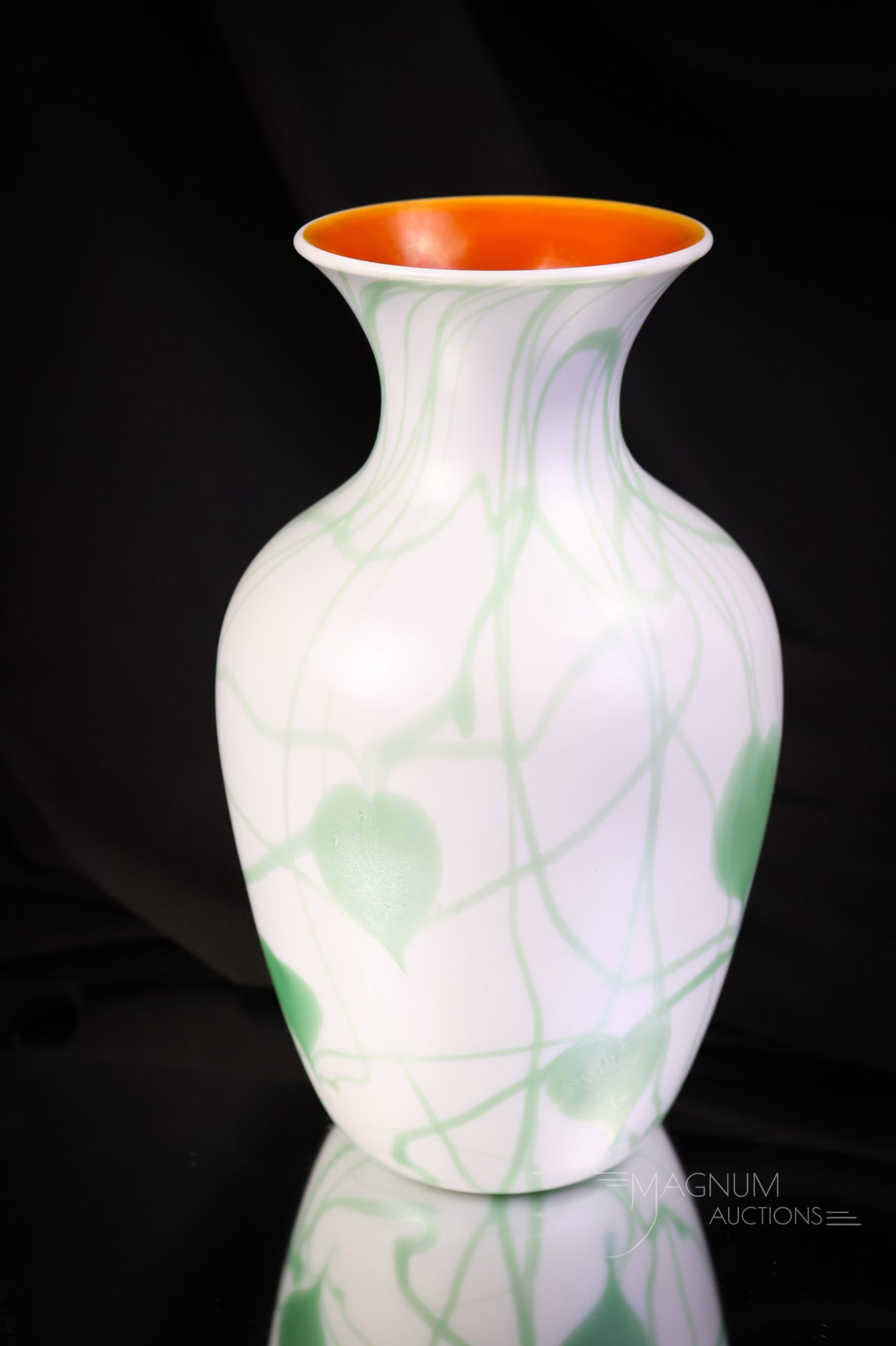 Imperial Freehand Lead Lustre Green White & Orange Art Glass vase: A fine example of Imperial Freehand Lead Lustre Art Glass. This vase is in white with green heart & Vine decoration and an orange interior. The vase measures 8" tall and 4 1/4" wide. SHIPPING NOTICE: 