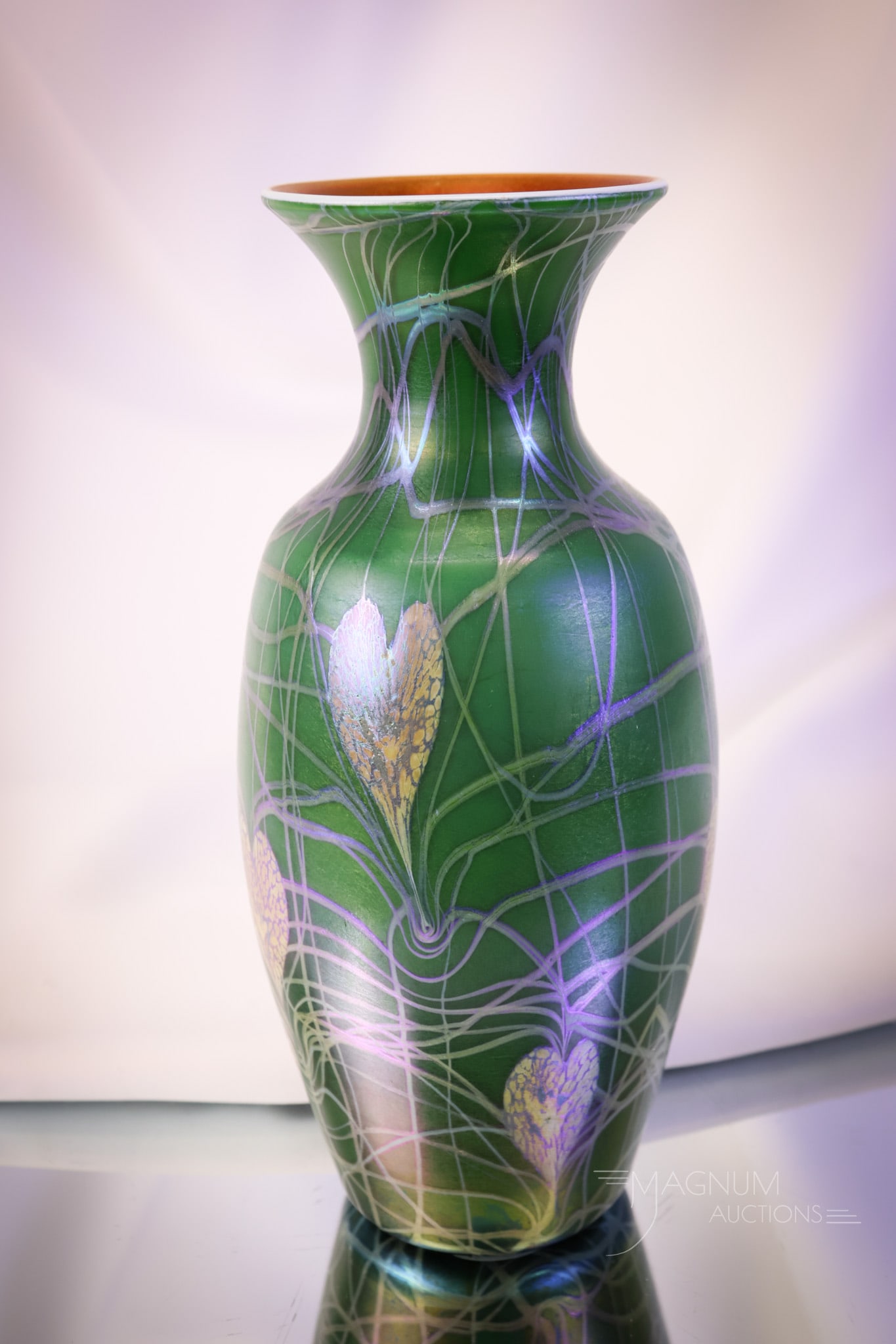 Imperial Freehand Lily Pad & Vines Iridescent Art Glass Vase: A beautiful Imperial art glass freehand vase. This piece is in a dark green color with lily pad and vine decoration and an orange interior. The vase has an iridescent finish. The vase measures 10 1/4"