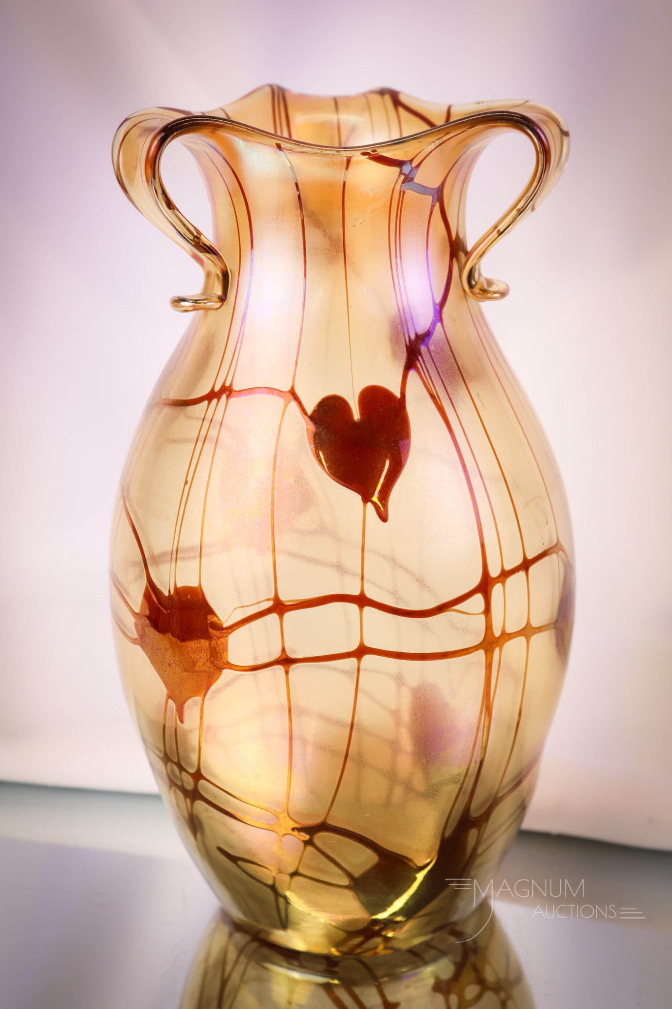 Imperial Freehand Ruby Heart & Vine Rabbit Ear Iridescent Art Glass Vase: A perfect Imperial Freehand ruby heart and vine decorated iridescent art glass vase. The vase has 3"rabbit ear" handles. Special Lot #2000, FH #343. The vase is a colorless base glassand overall orang