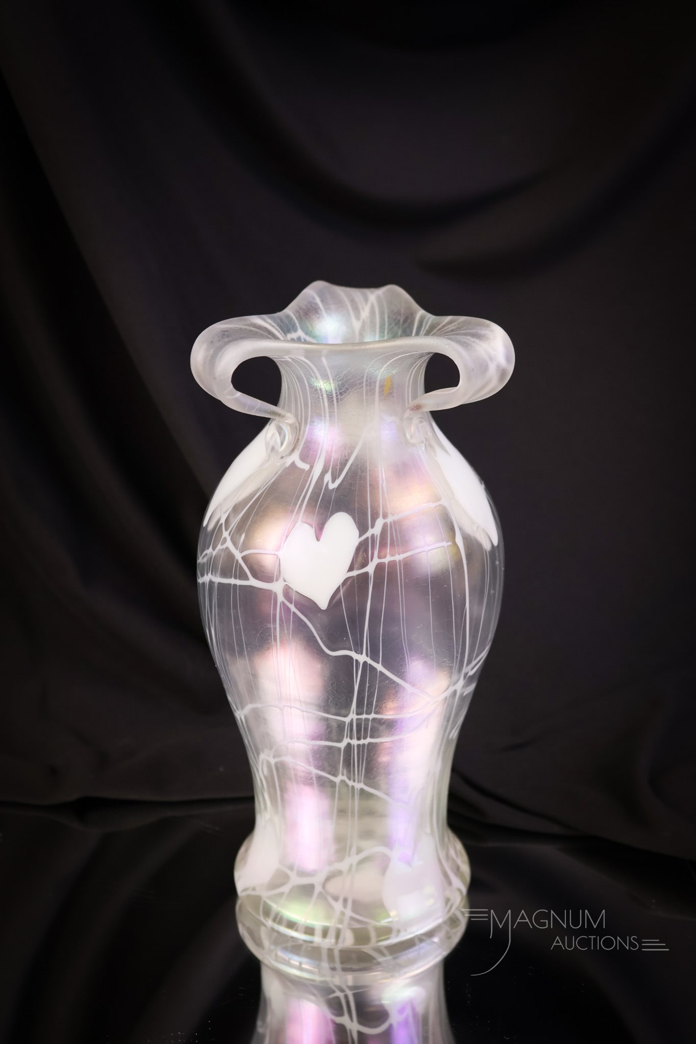 Imperial Freehand Clear Iridescent Heart & Vine Rabbit Ear Vase: A nice piece of Imperial freehand art glass. This vase is as-is. There is a loss noted on one handle. The vase is in clear iridescent with white heart & vine decoration. The top has three rabbit ear h