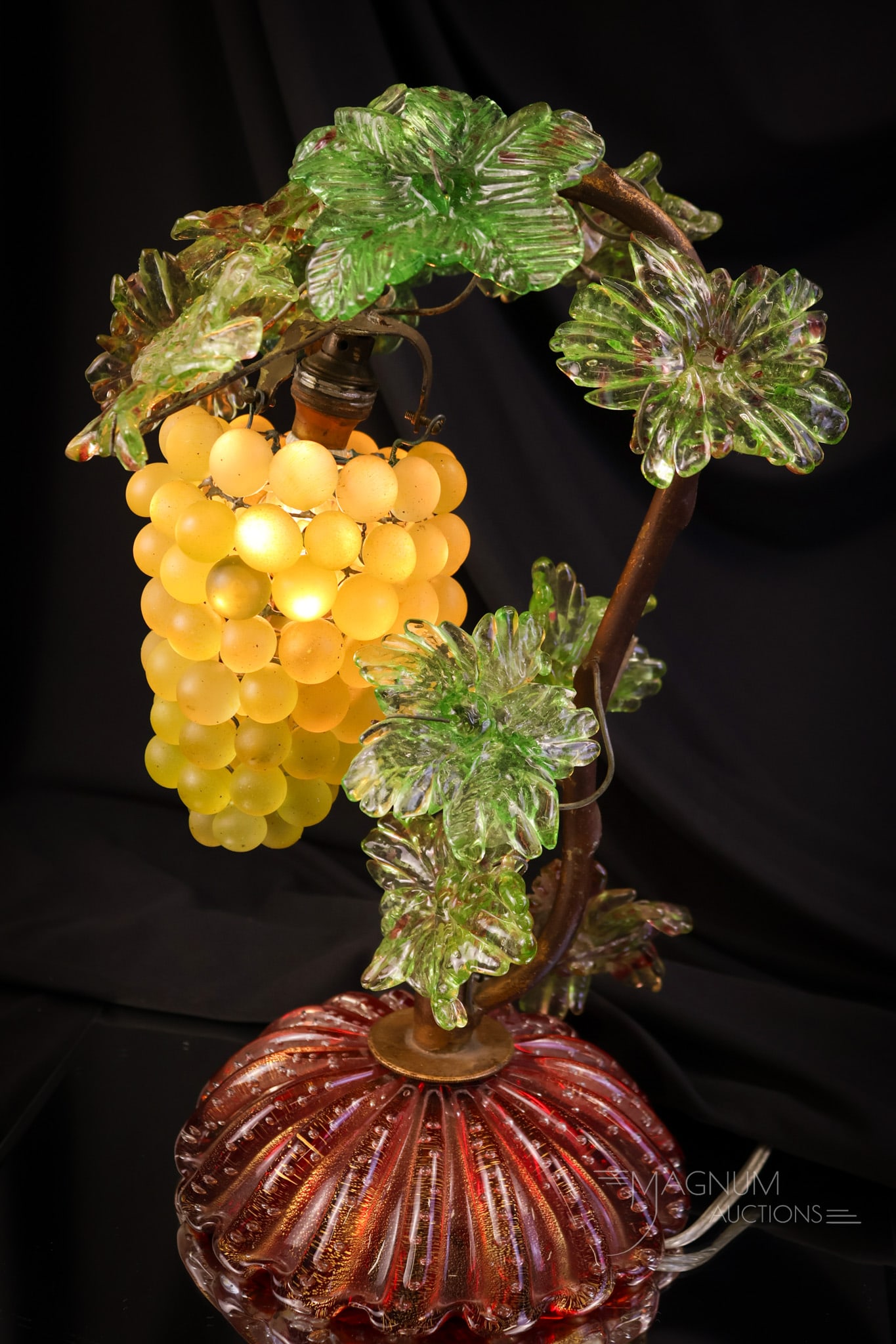 Italian Murano Art Glass Figural Grape Cluster lamp: A beautiful antique Italian Murano art glass figural grape table lamp. This lamp has a cluster of yellow glass grapes. The leaves are red and green variegated. The glass base is bittersweet in color a