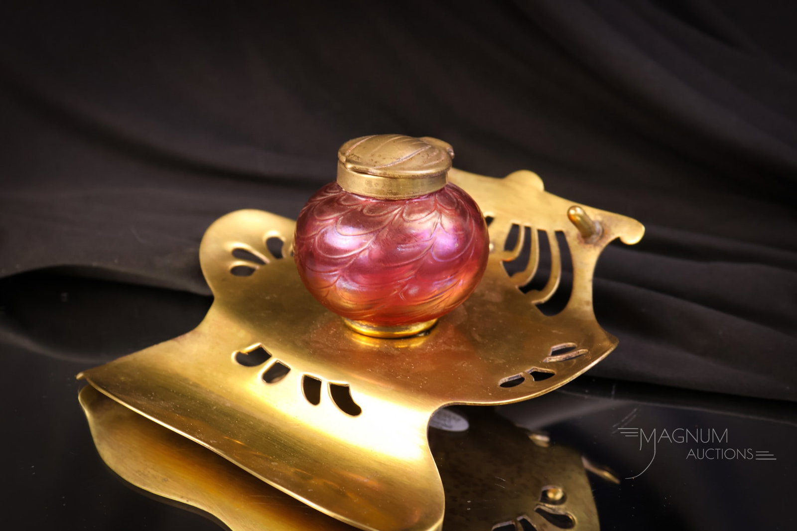 Kralik Red Iridescent Art Glass Art Nouveau Inkwell: A beautiful piece of Art Nouveau in a functional decorative item. This is a red iridescent art glass Kralik inkwell in a brass Art Nouveau stand. This piece shows well. It measures 3 1/2" tall and 6" 