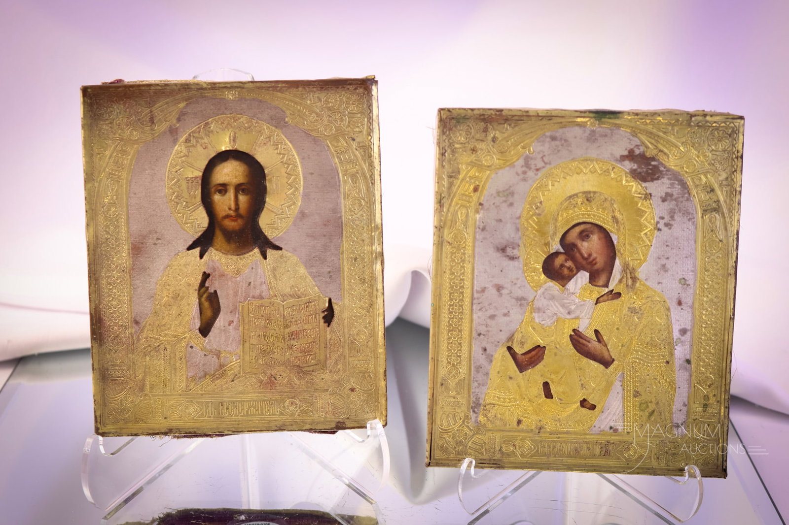 2 pc Lot Antique Russian Religious Icons: two desirable collection-enhancing finds in this lot of Russain religious icons. Both are in brass frames. The first is of Jesus. The second is of Mary and Baby Jesus. The tallest measures 5 3/4". SHI