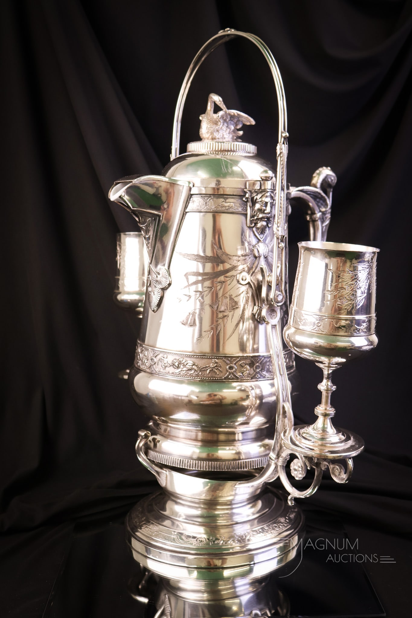 Reed & Barton Victorian Silverplate Swan Figural Bird Double Tipler: A beautiful piece of Victorian Silverplate. This is signed Reed & Barton. This is a double tipler. It features two goblets. One on either side. The pitcher has a figural swan on the lid, and the handl