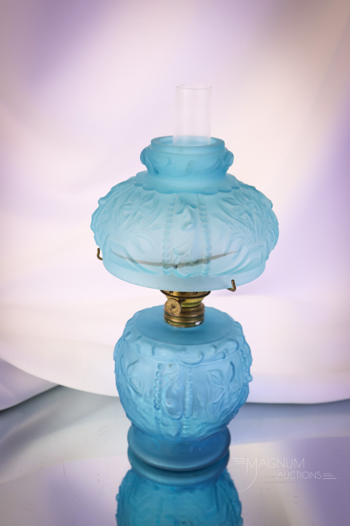 Teal Blue Satin Fostoria Wild Iris Victorian Miniature Oil Lamp: A teal blue satin Fostoria Wild Iris Victorian miniature oil lamp. This one is a seldom-seen find. The lamp measures 7 1/2" tall and 5" wide. SHIPPING NOTICE: If you choose not to utilize the LiveAuct