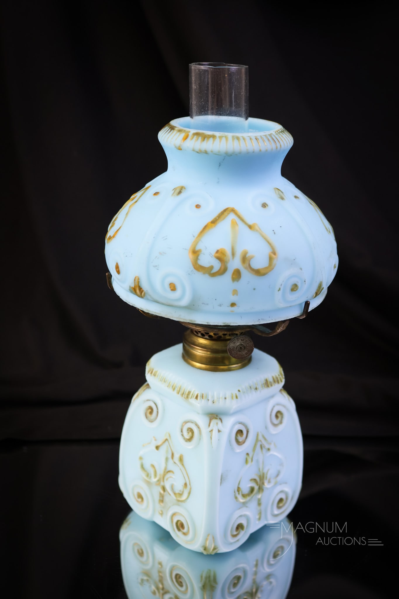 Blue Satin Gilt Decorated Victorian Glass Miniature Oil Lamp: A pretty little Victorian glass miniature oil lamp in blue satin with gold decoration. This lamp features a scrolling design. It measures 8" tall and 4" wide. SHIPPING NOTICE: If you choose not to uti