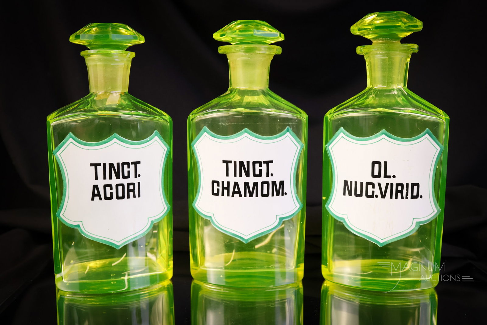 3 pc Lot Antique Victorian Uranium Vaseline Glass Apothecary Bottles Enameled Labels: A select offering of three antique vaseline uranium enameled glass apothecary bottles. These are labeled, "Tinct Acori", "Ol Nug. Virio", and "Tinct Chanom." The tallest measures 6 1/2". SHIPPING NOTI
