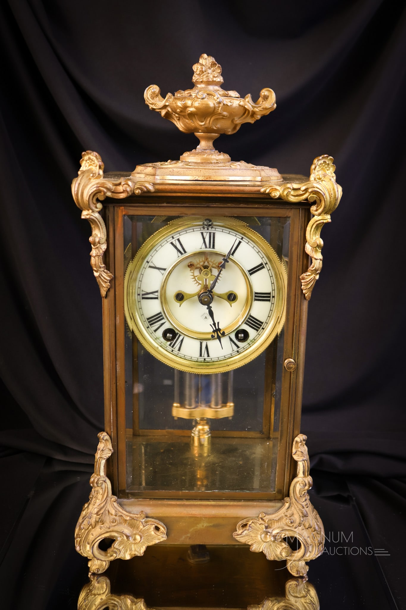 Antique Gilt Ansonia Crystal Regulator Clock: A beautiful Ansonia crystal regulator clock with gilt case. This clock appears to work, although untested. It is found with its pendulum and key. The case for the clock is quite decorative and feature