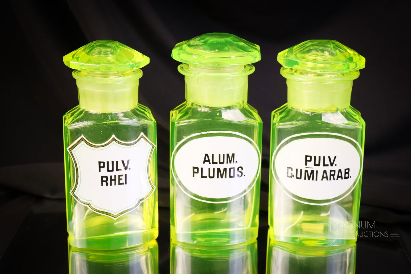 3 pc Lot Antique Victorian Uranium Vaseline Glass Apothecary Bottles Enameled Labels: Three select examples of antique apothecary vase uranium glass bottles with enameled labels. The labels read, "Pulv Rhei", "Pulv Gumi Arab", and "Alum Plumos." The tallest measures 6". These are rarel